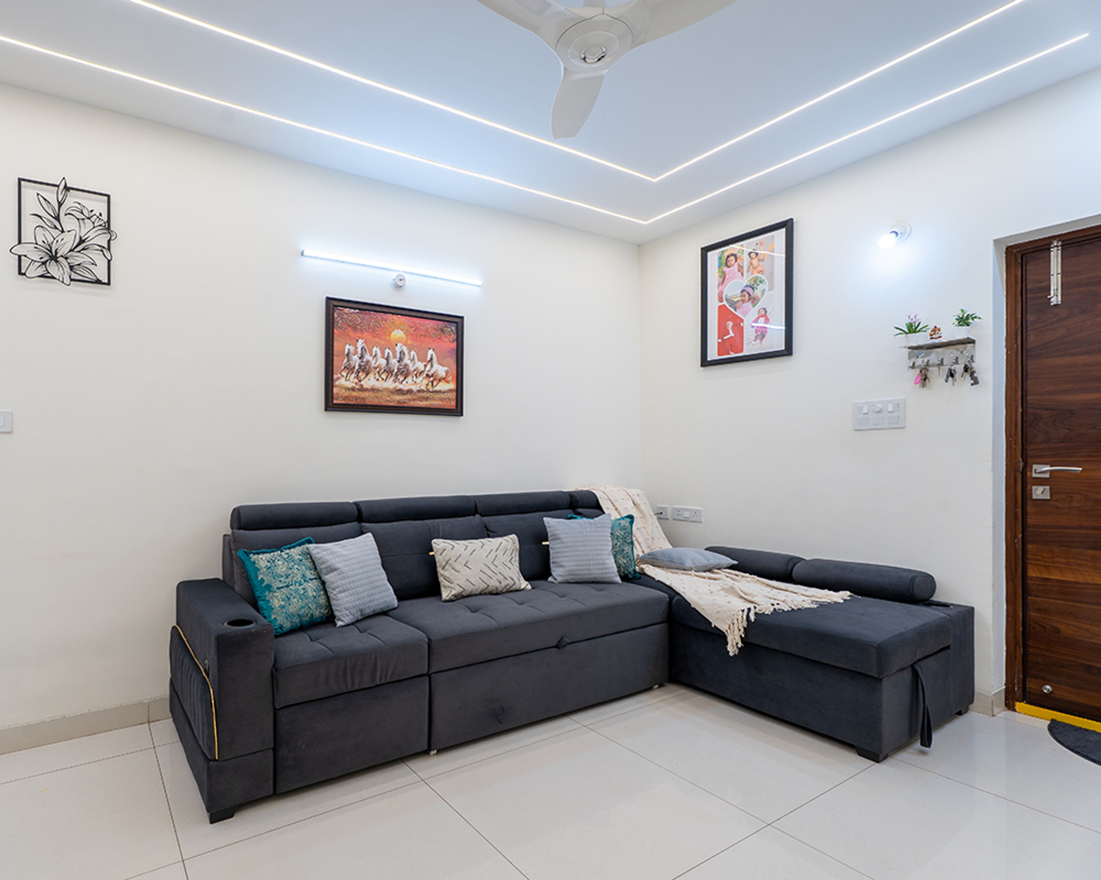 Living Room Design with Dark Grey L-Shaped Sofa and Wall Paintings