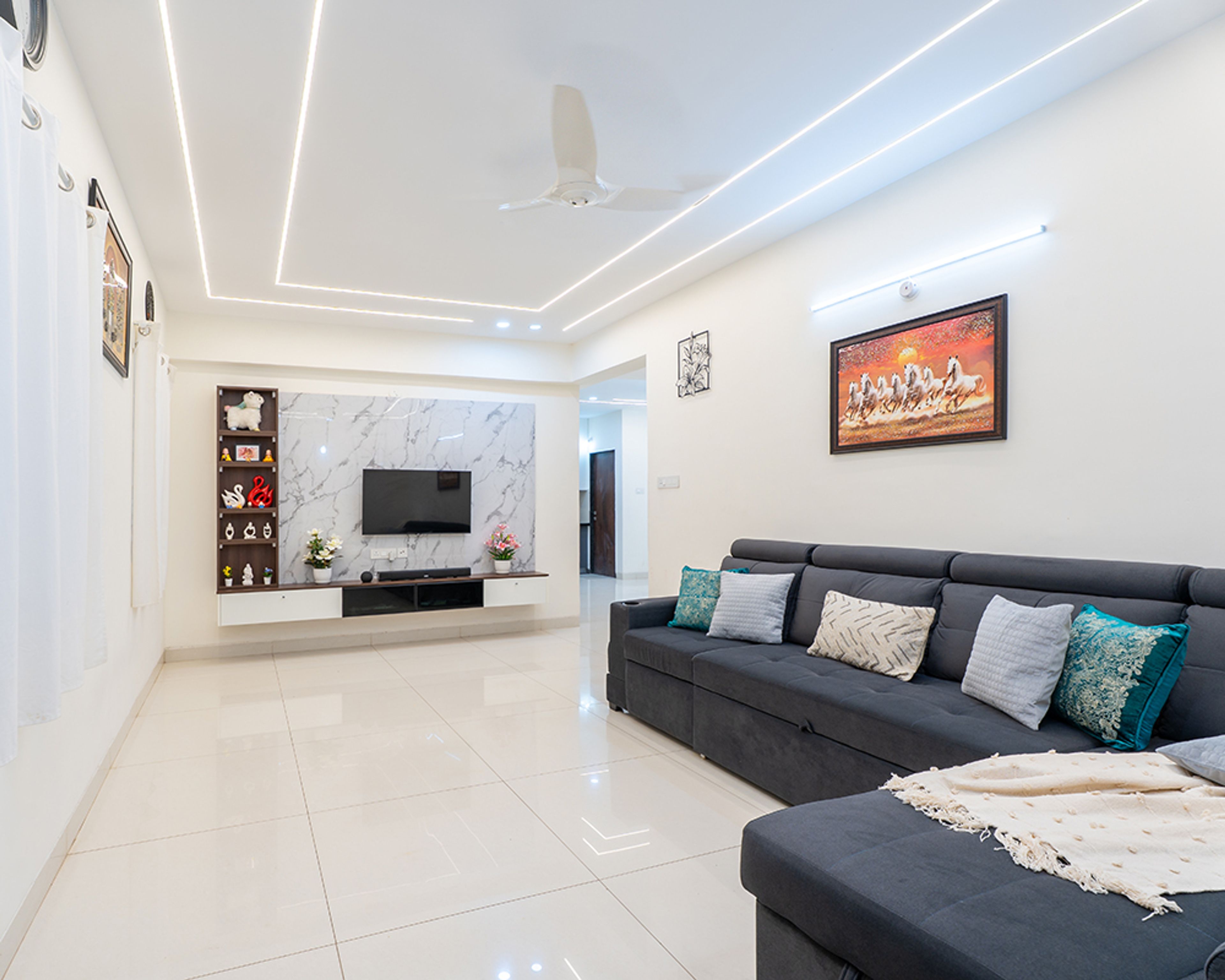Living Room Design with Dark Grey L-Shaped Sofa and Marble Patterned TV Unit