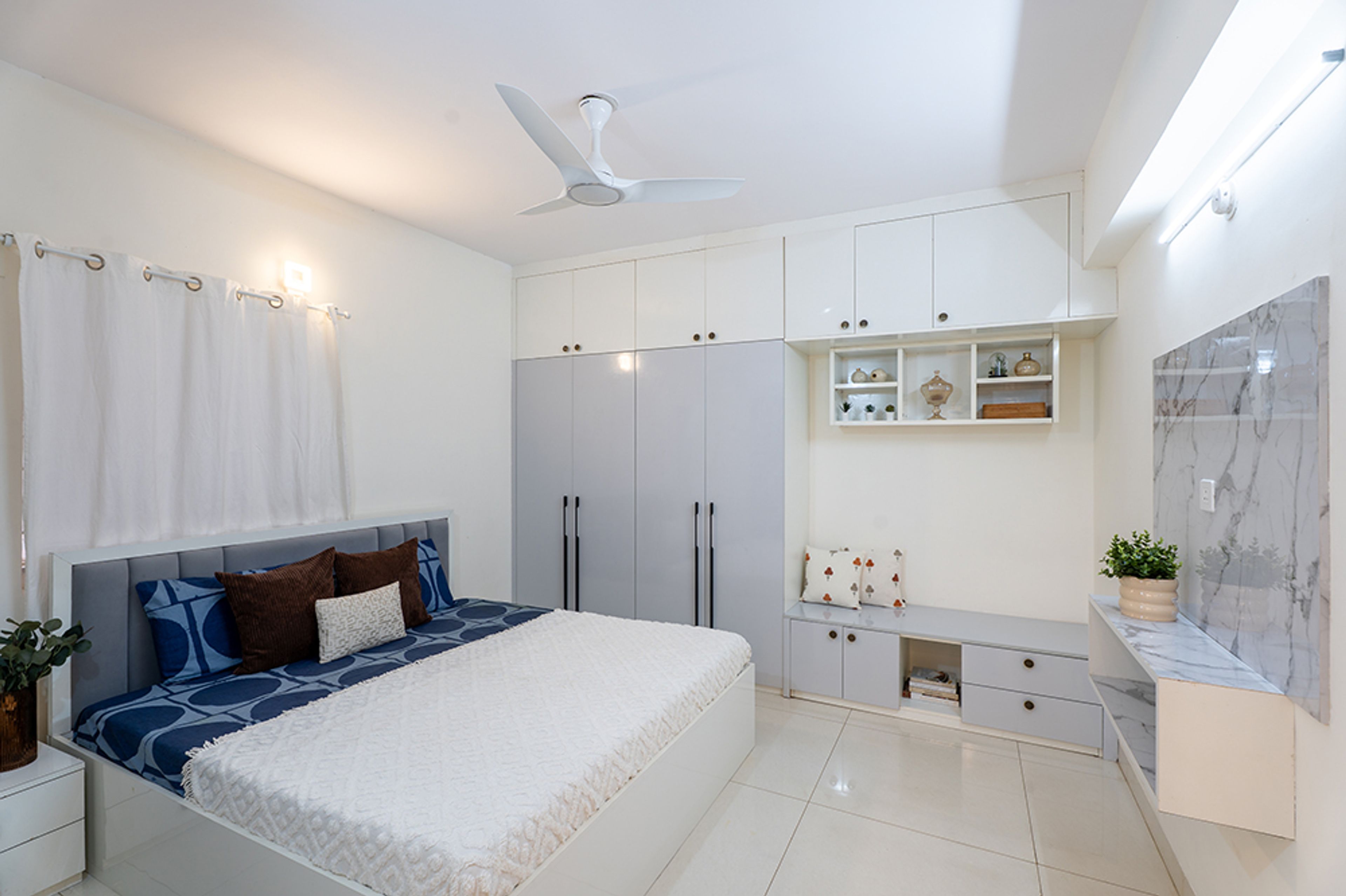 Master Bedroom Design with White and Grey Swing Wardrobe and Marble Panel TV Unit