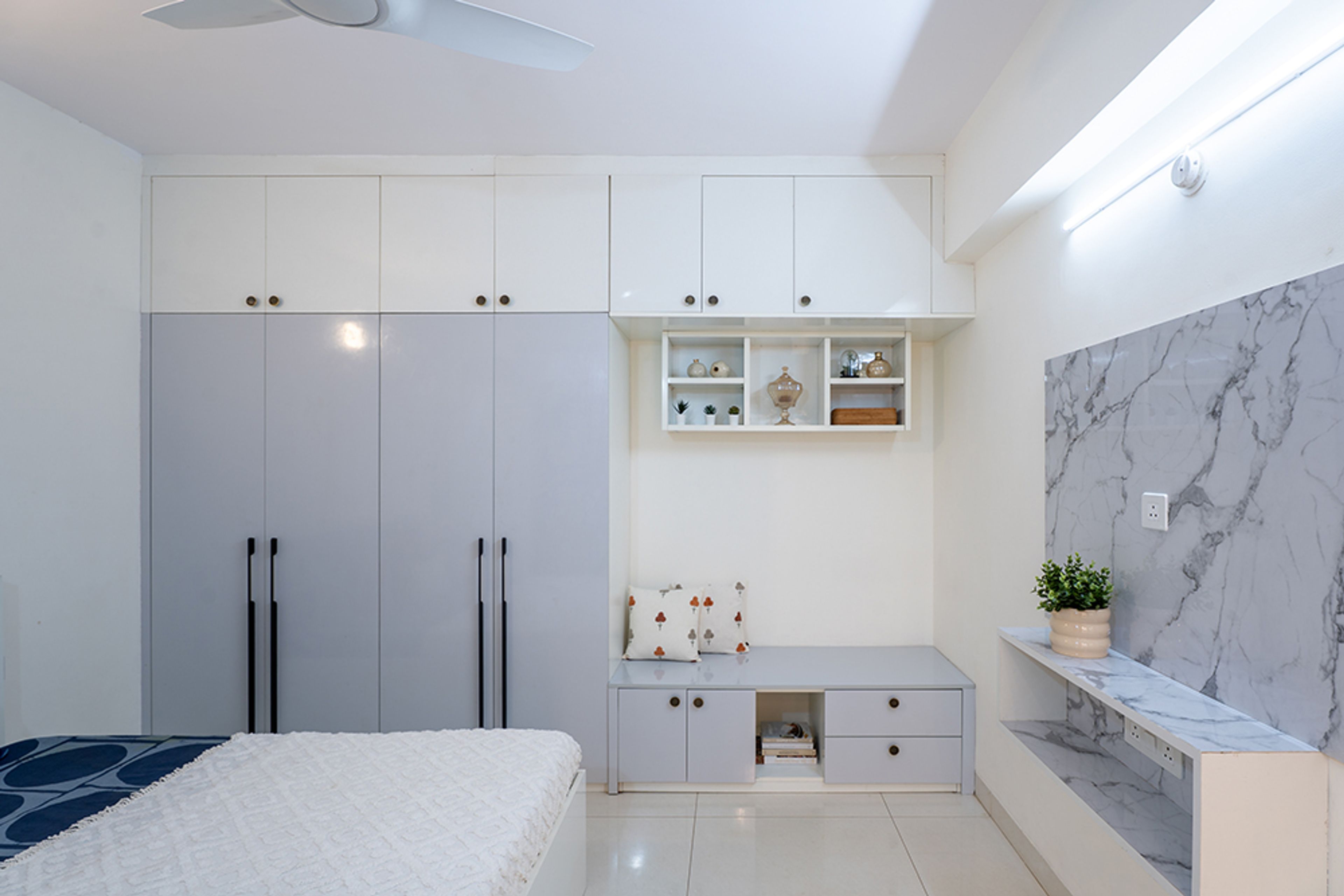 Swing Wardrobe Design with White and Grey Doors and Seating Space with Storage