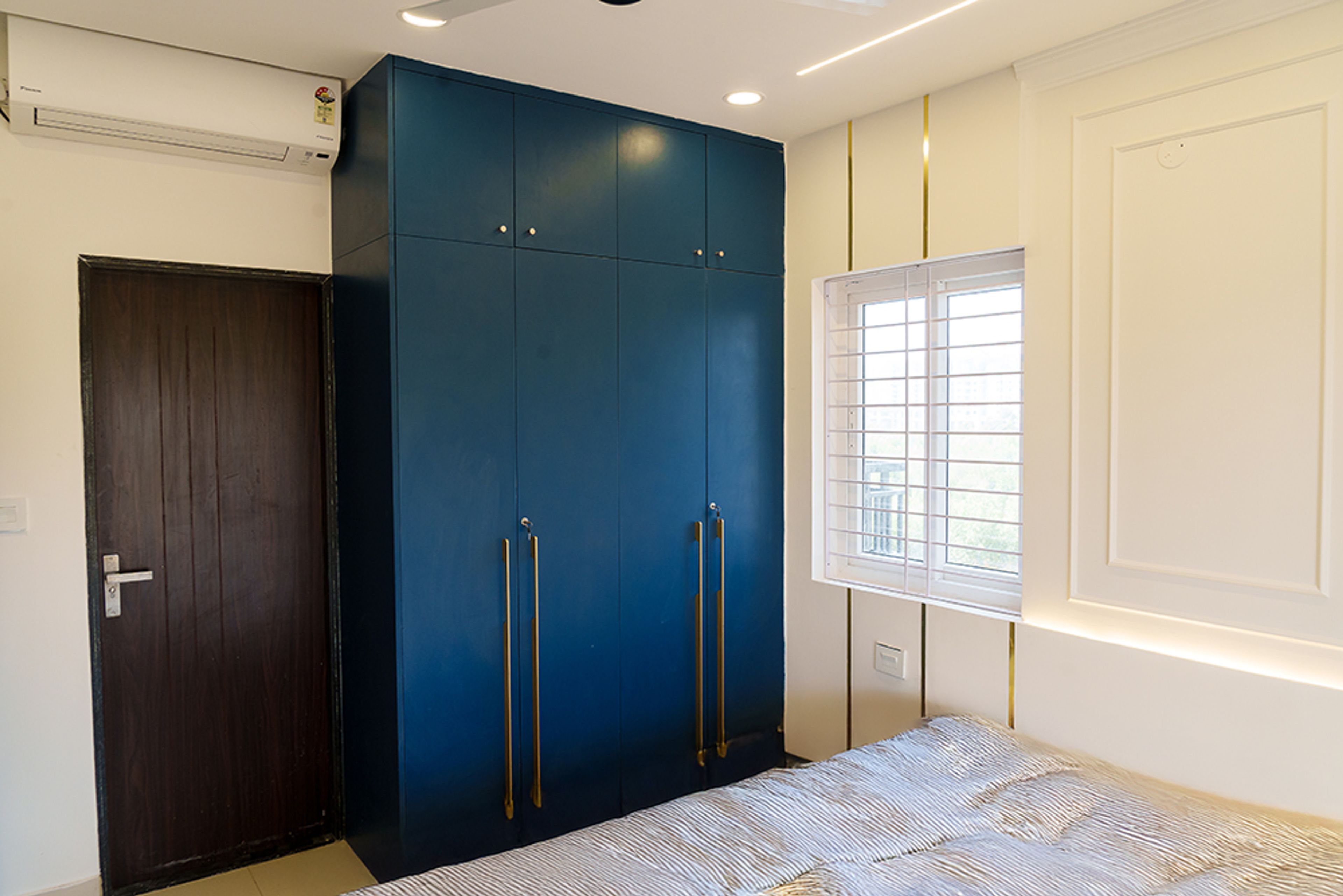 Bedroom Design with 4-Door Blue Wardrobe with Gold Handles