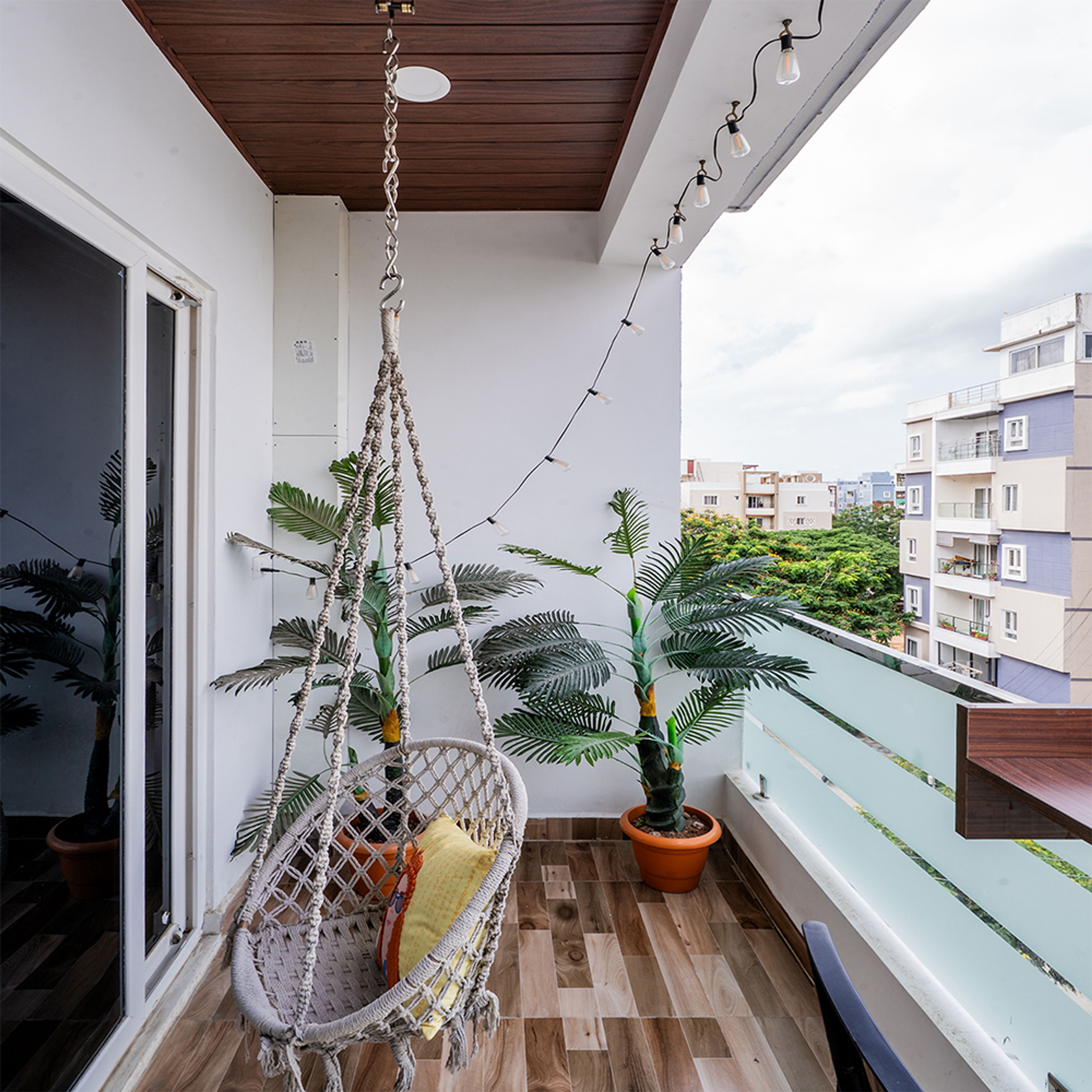 Balcony Design with Hanging Rope Chair and Wooden Flooring