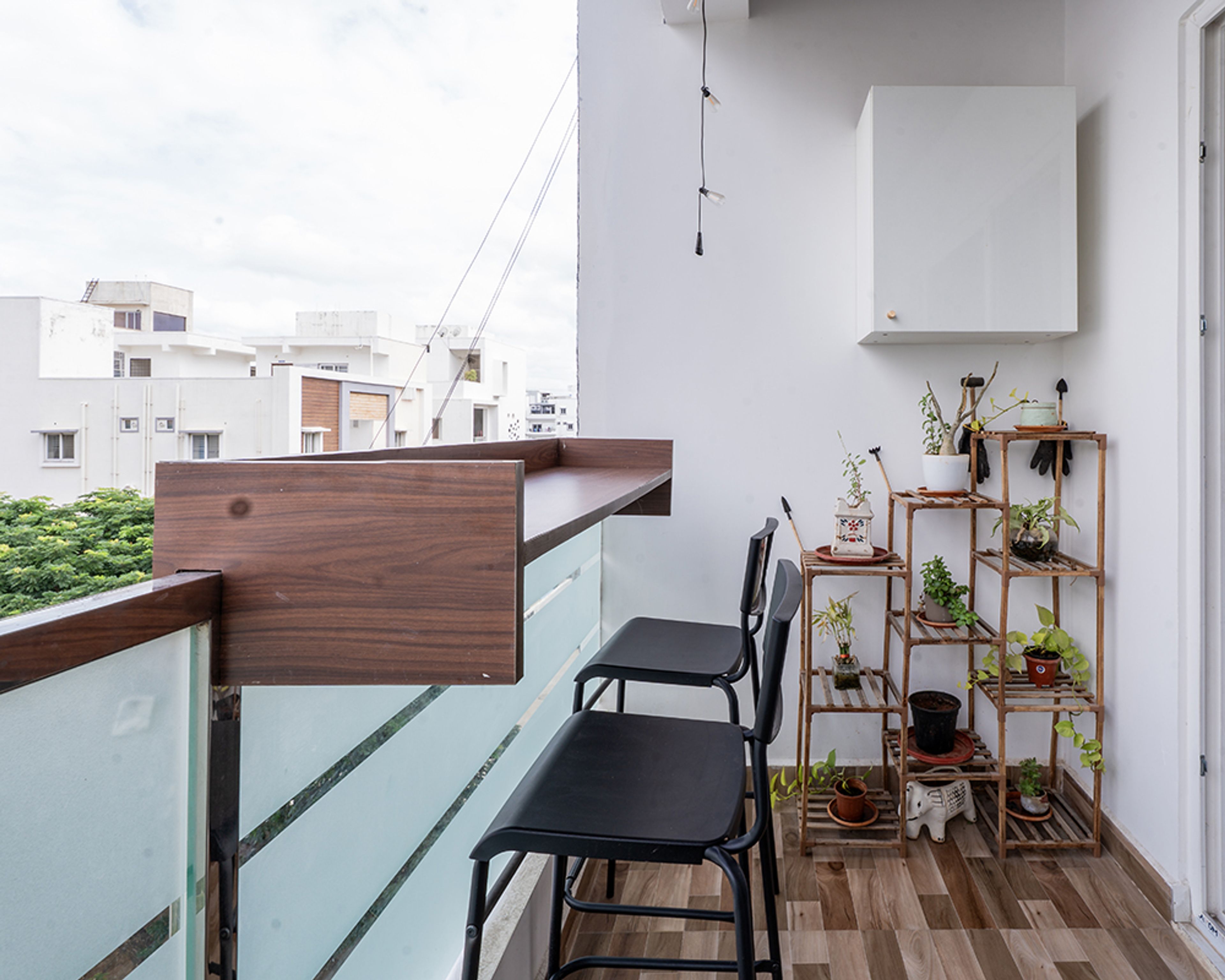 Balcony Design with Tall Wooden Counter and Black Bar Stools