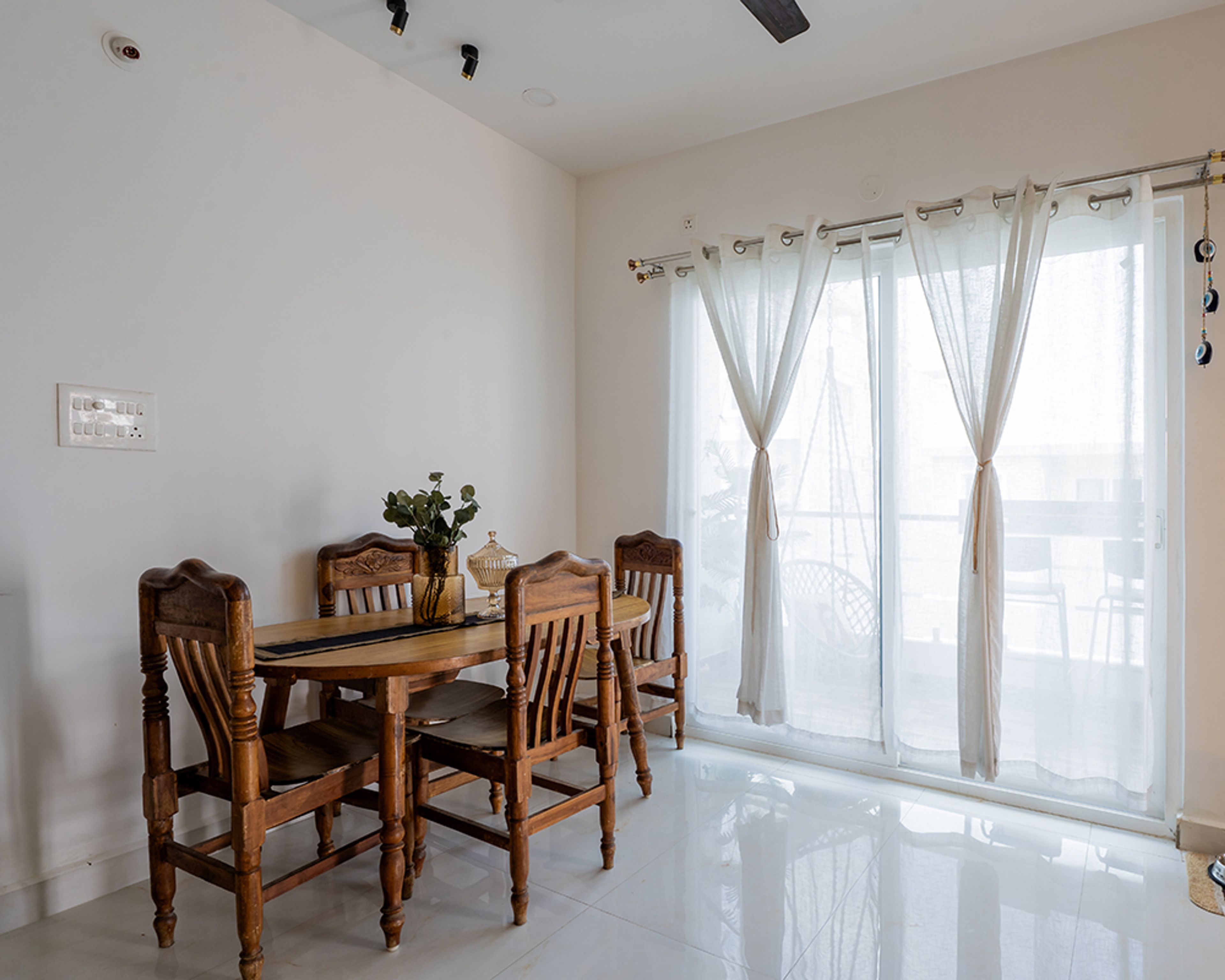 Dining Room Design with Wooden Six-Seater Table and Sheer White Curtains