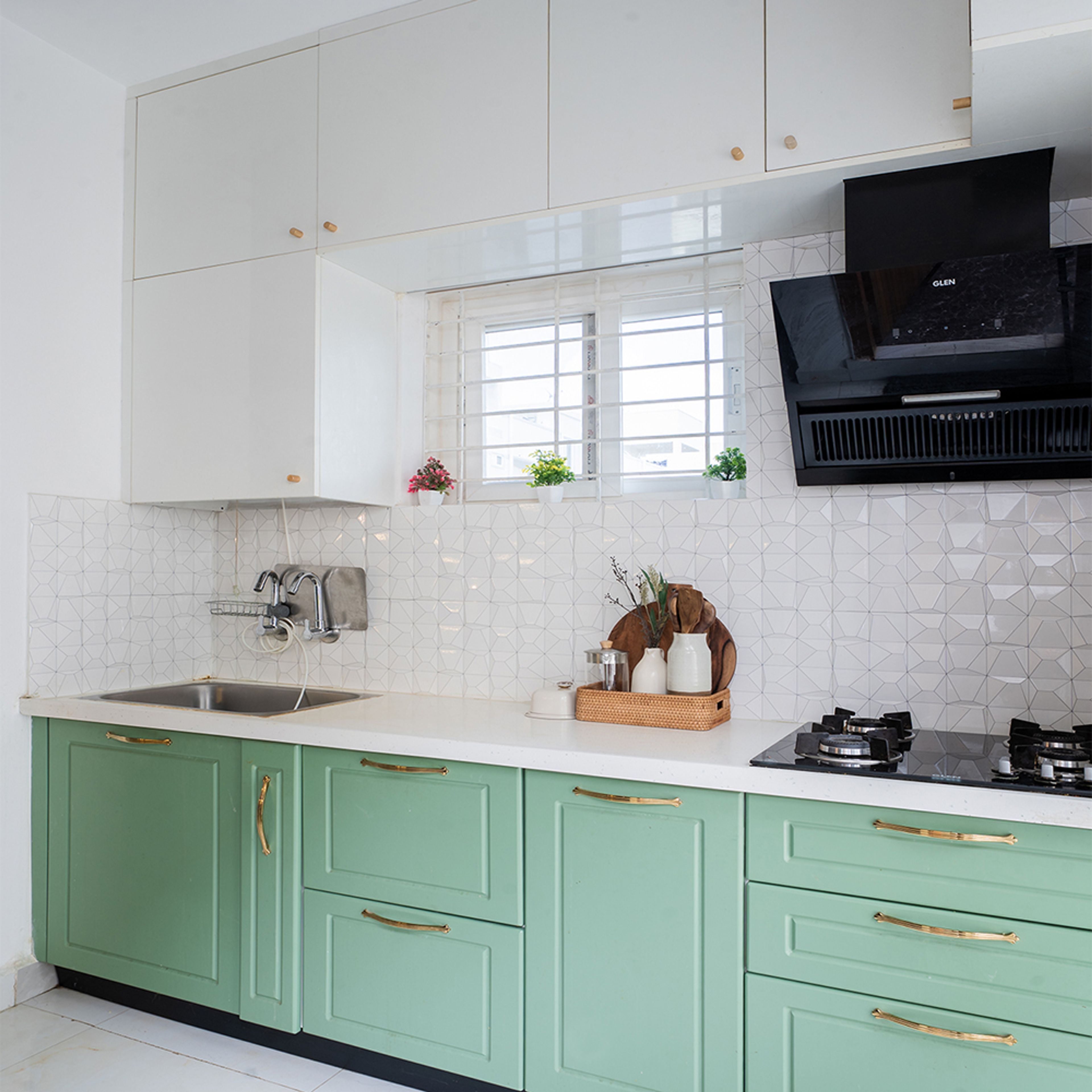 L-Shaped Kitchen Design with Green Base Cabinets and White Wall Tiles