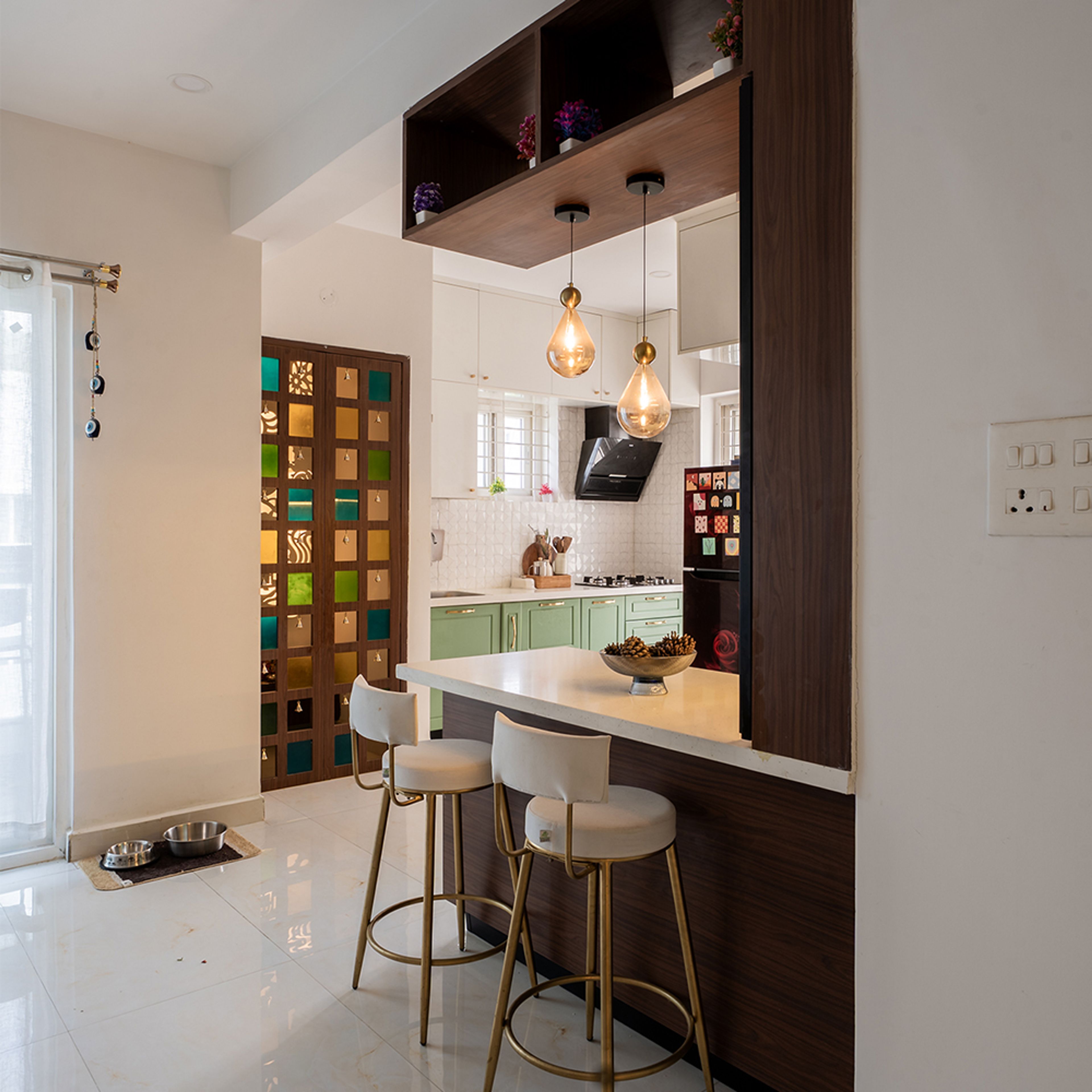 L-Shaped Kitchen Design with Breakfast Counter, Pendant Lights, and Green Cabinets