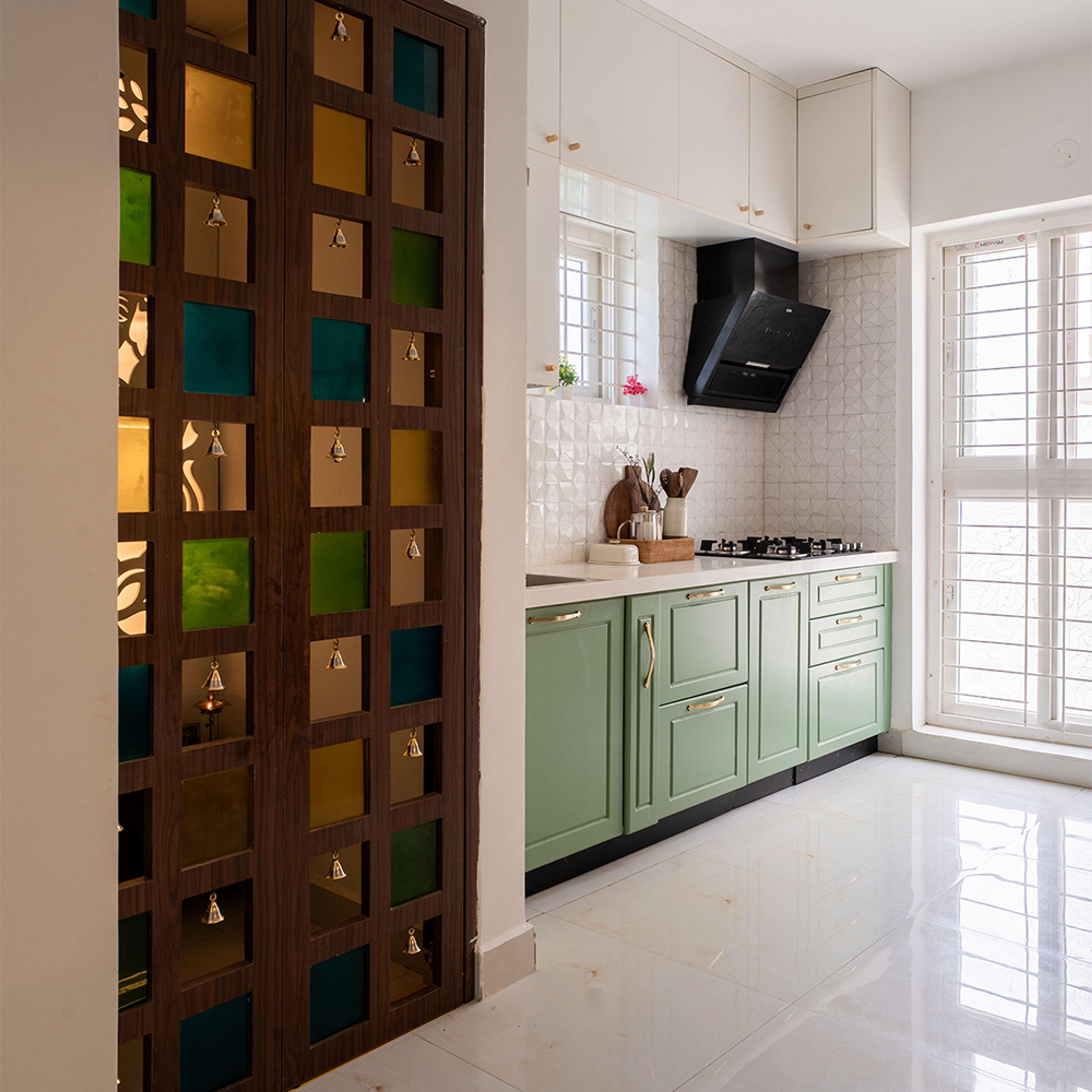 L-Shaped Kitchen Design with Green and White Cabinets and Wooden Bell Door Pooja Room