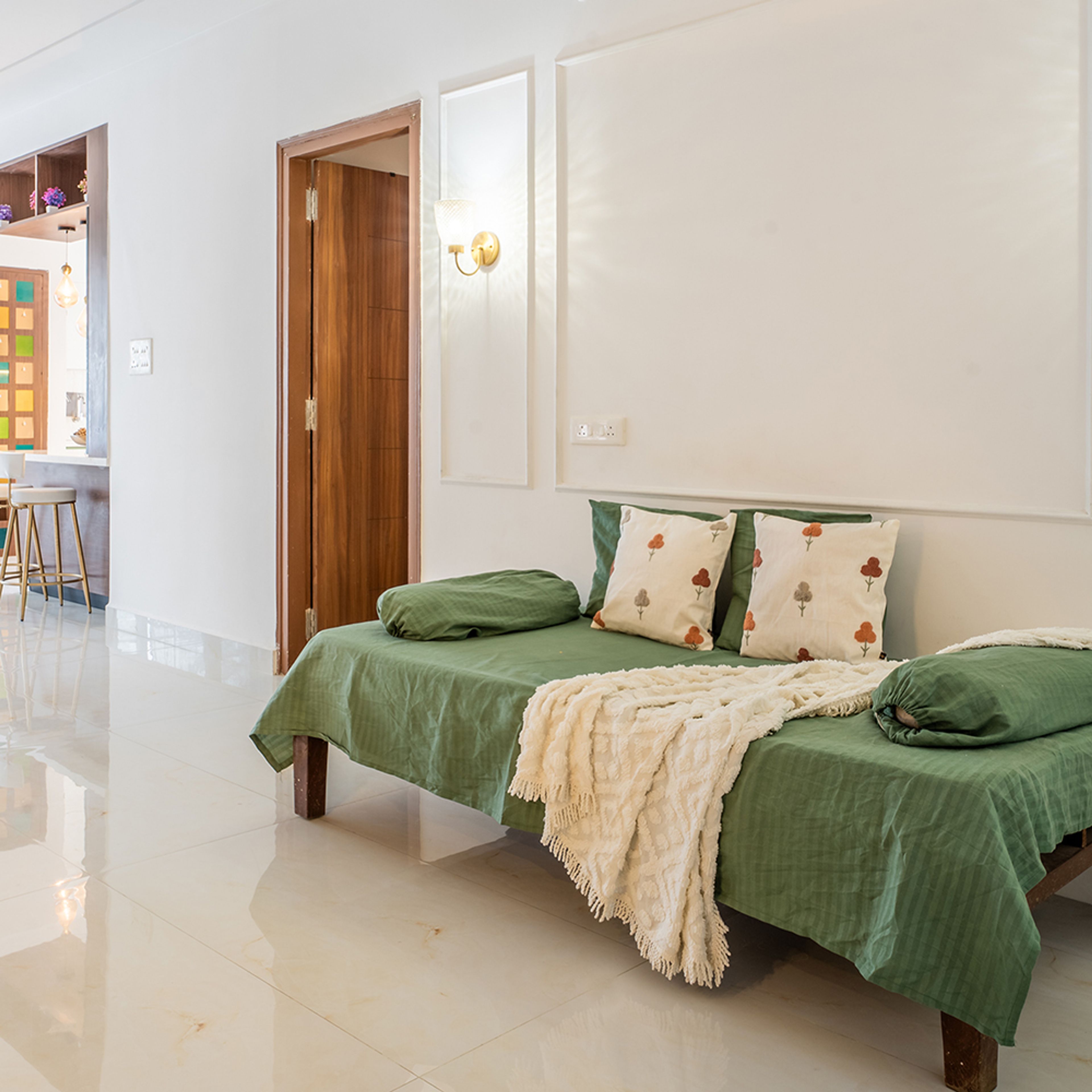 Living Room Design with Green Diwan and Panelled Wall
