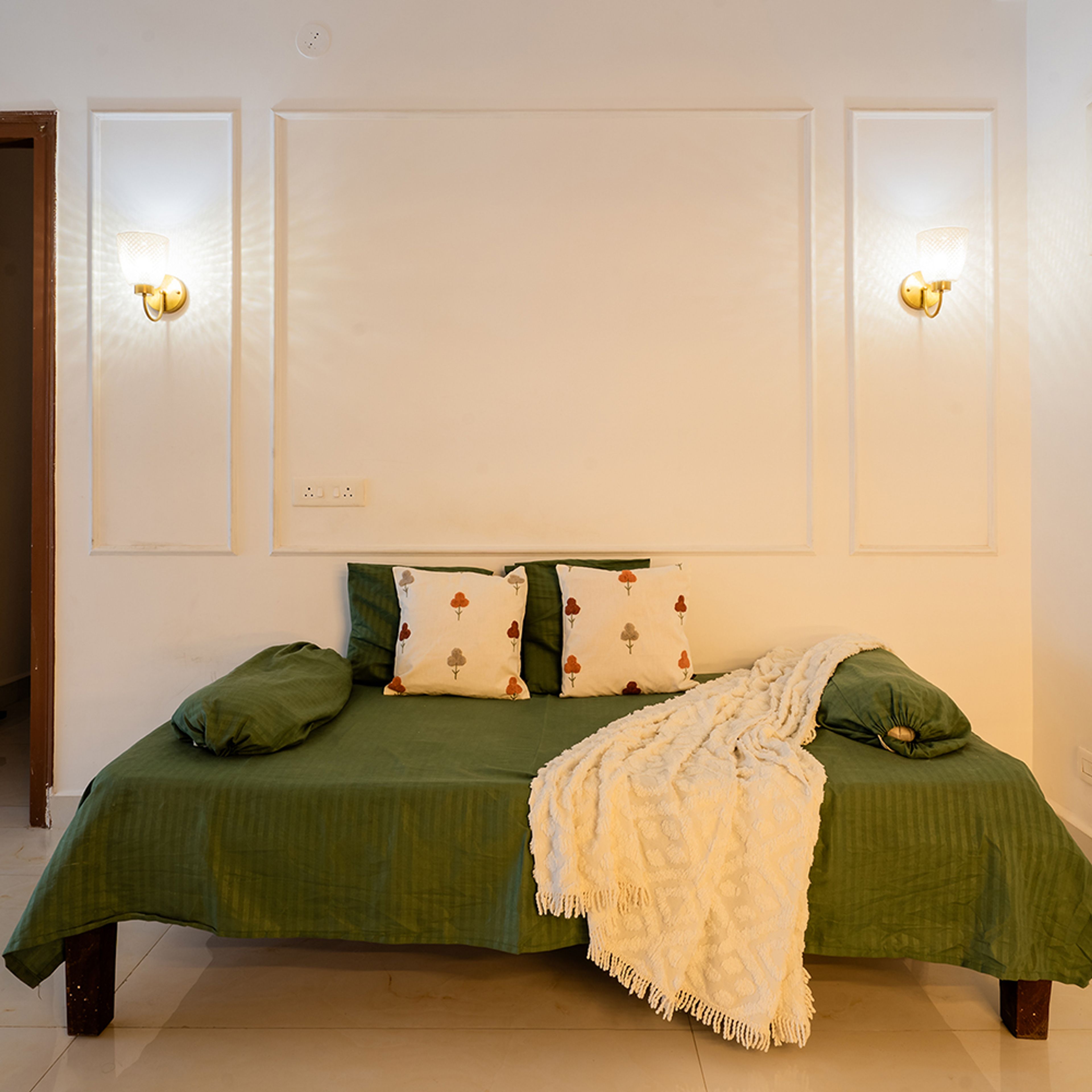 Living Room Design with Green Diwan and Panelled Wall