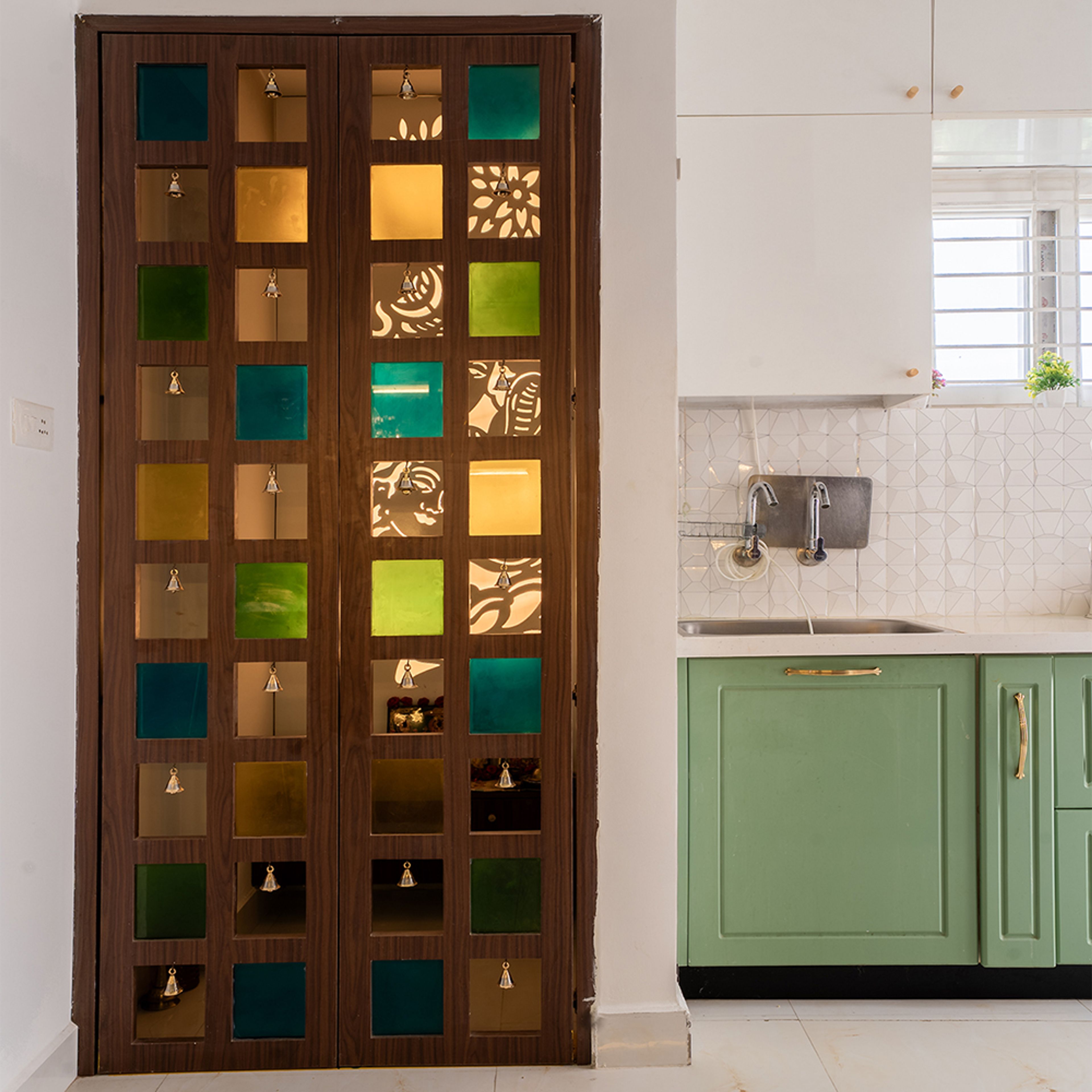 Pooja Room Design with Wooden Doors and Multicolour Glass Panels