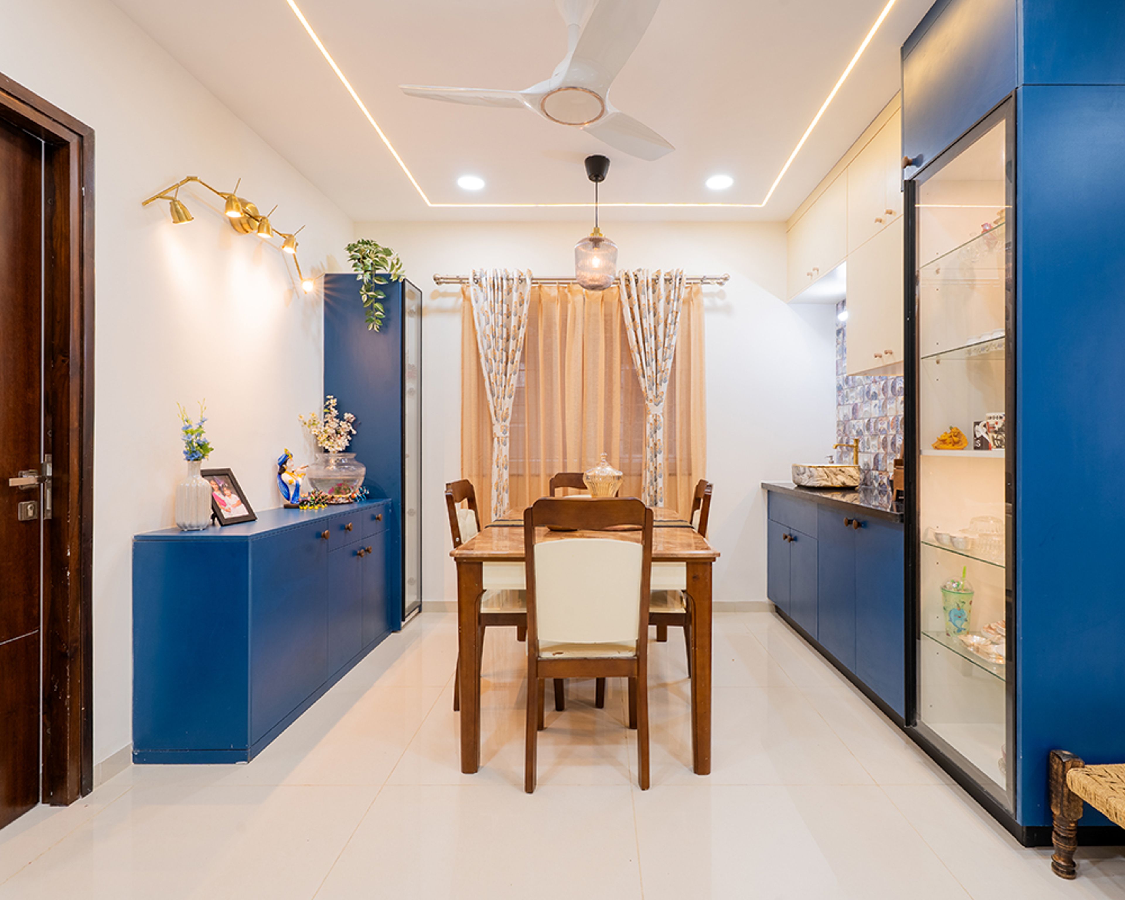 Dining Room Design with Blue Crockery Units and Glass Display Cabinet