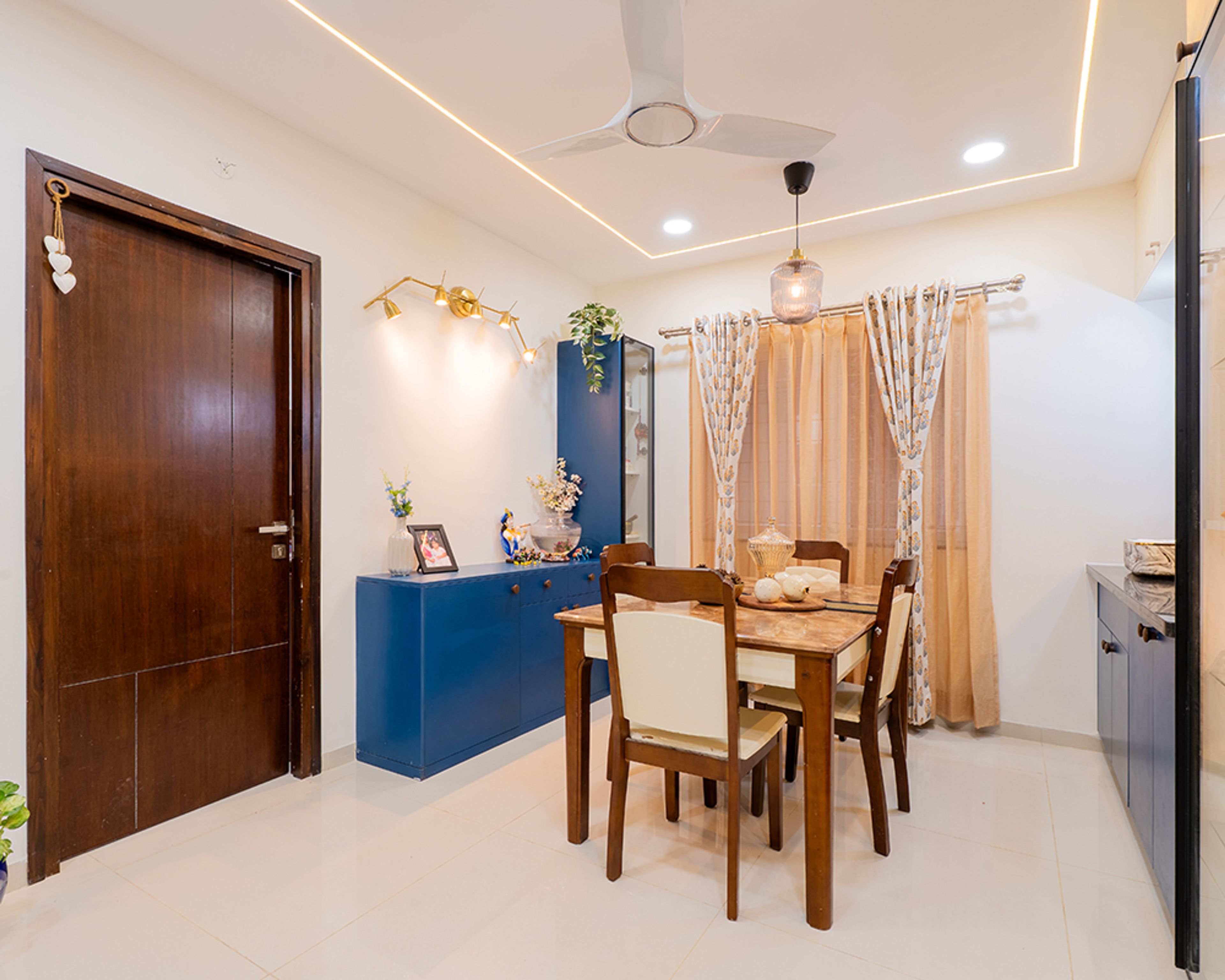 Dining Room Design with Blue Storage Unit and Four-Seater Wooden Table