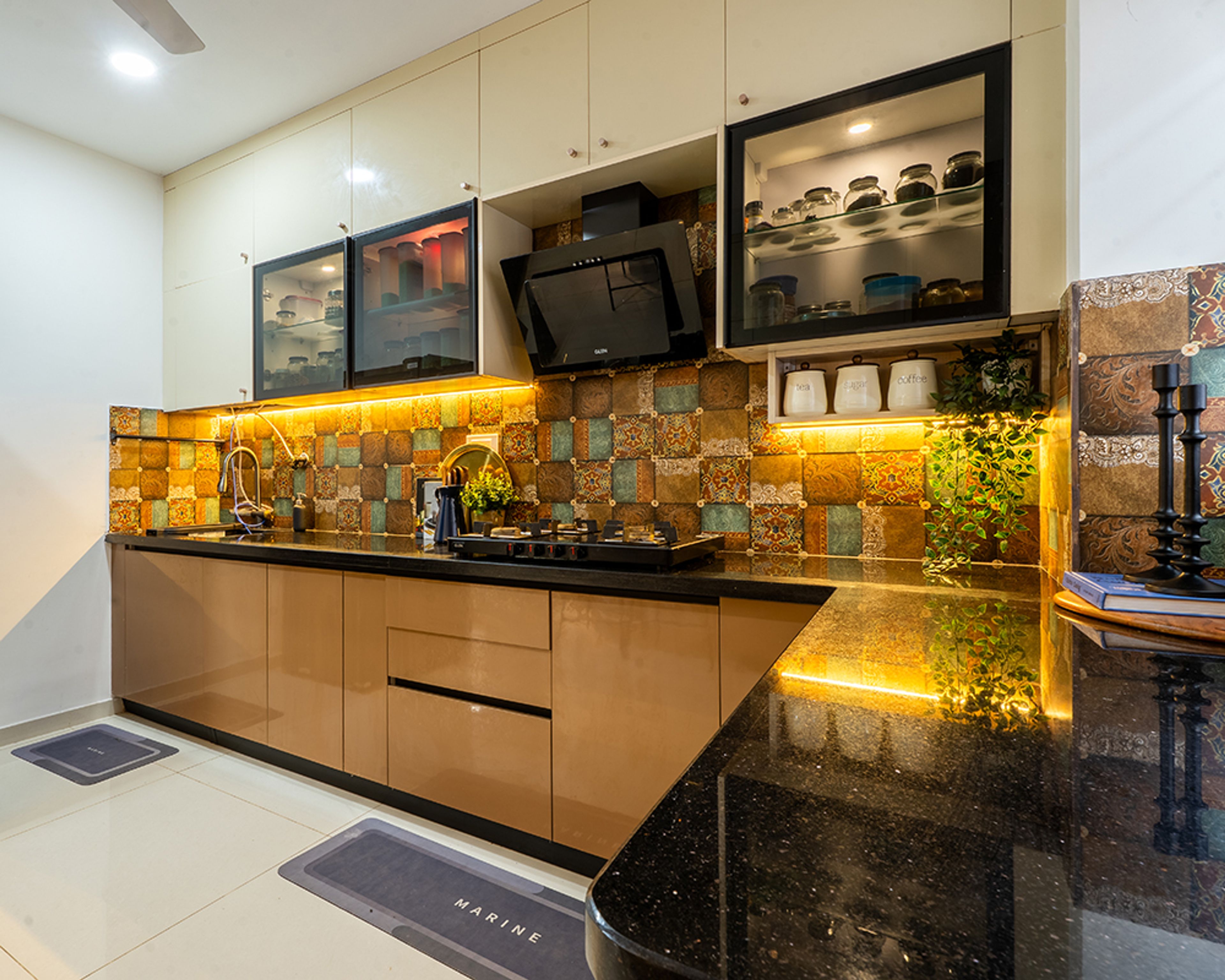L-Shaped Kitchen Design with Brown and Cream Cabinets and Patterned Tile Backsplash