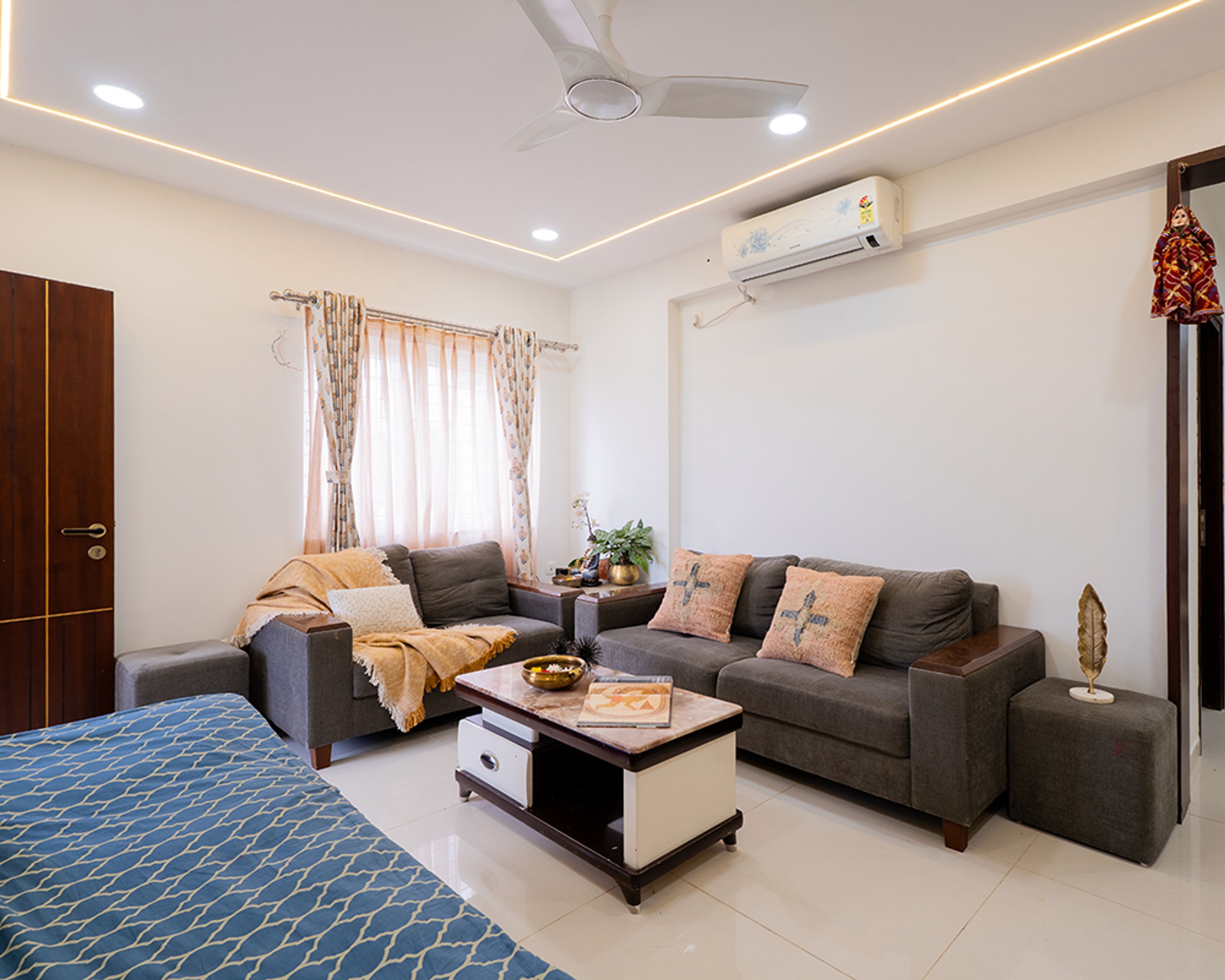Living Room Design with Grey Sofas, Wooden Coffee Table, and False Ceiling Lights