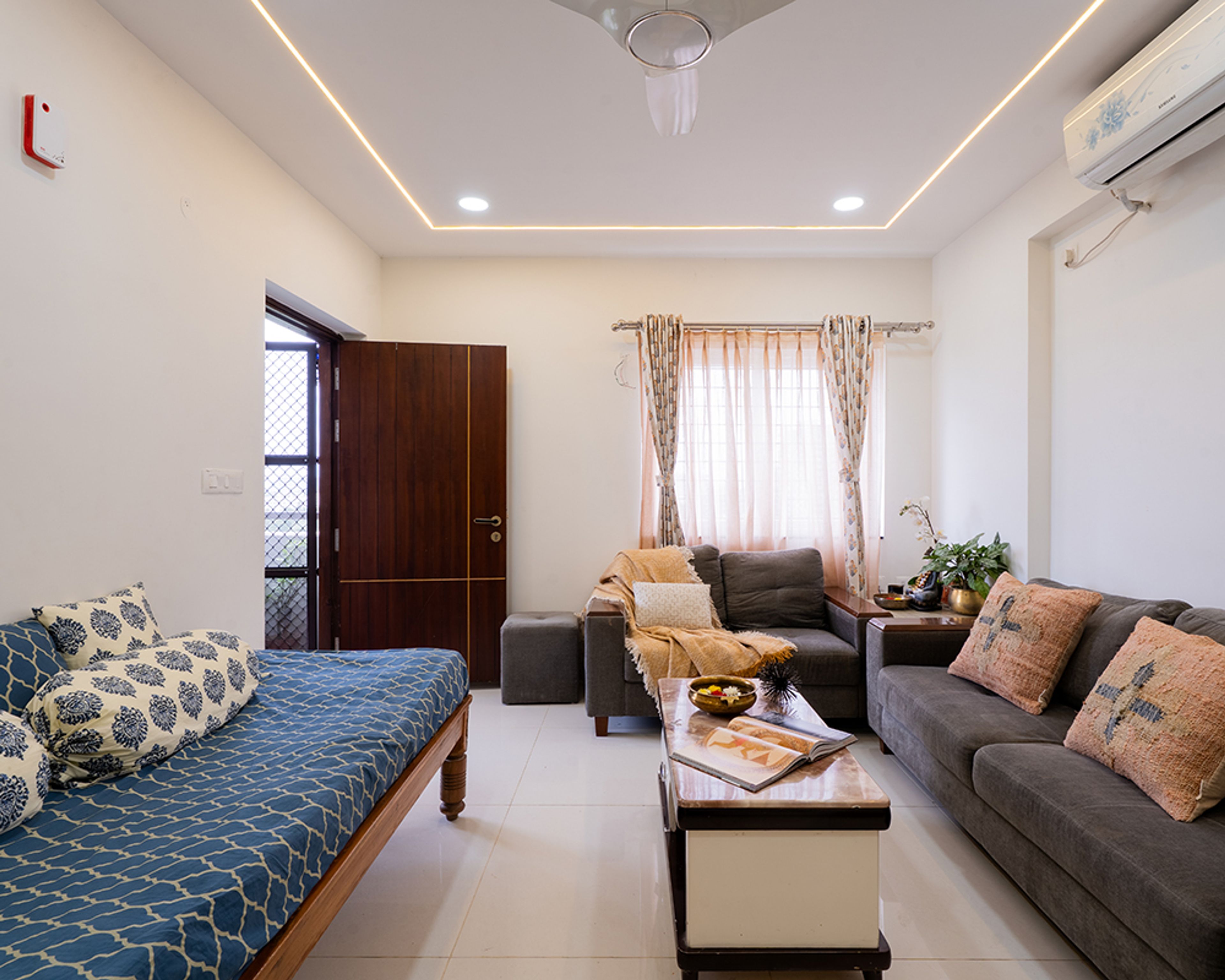 Living Room Design with Grey Sofas and Blue Printed Diwan