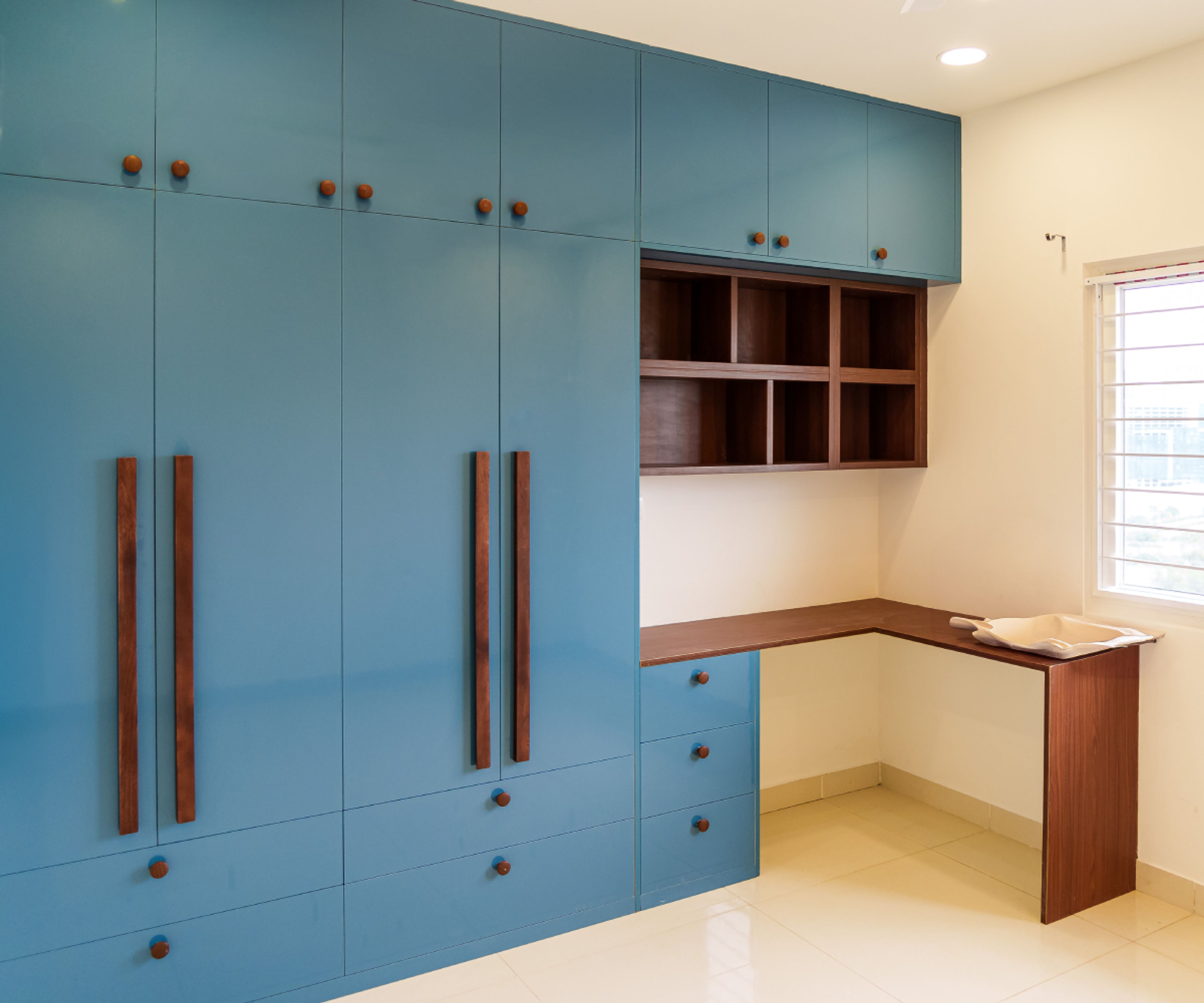 Master Bedroom Design with Blue 4-Door Swing Wardrobe with Wooden Study Space