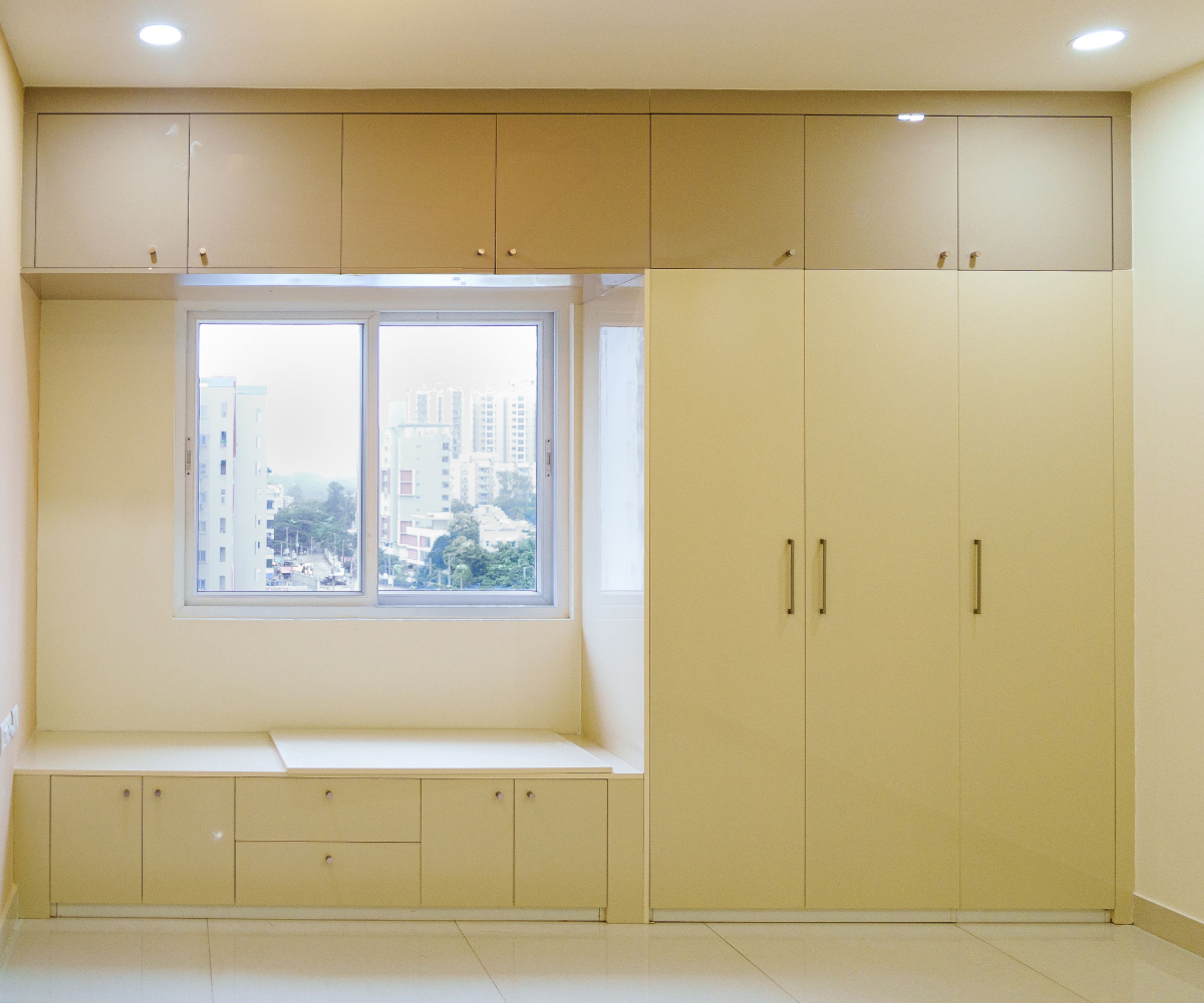 Yellow 3-Door Swing Wardrobe Design with Loft Unit and Seating Bench