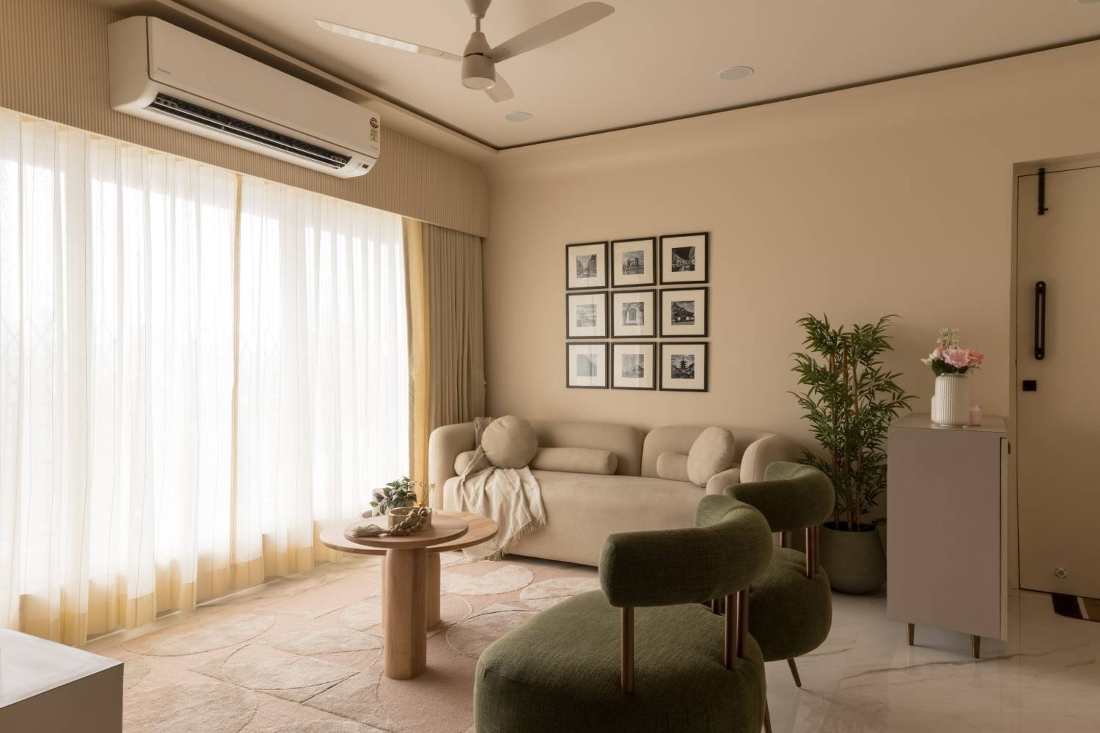 Minimal Beige Living Room Design With Curved Seating and Built-In Armrest Storage