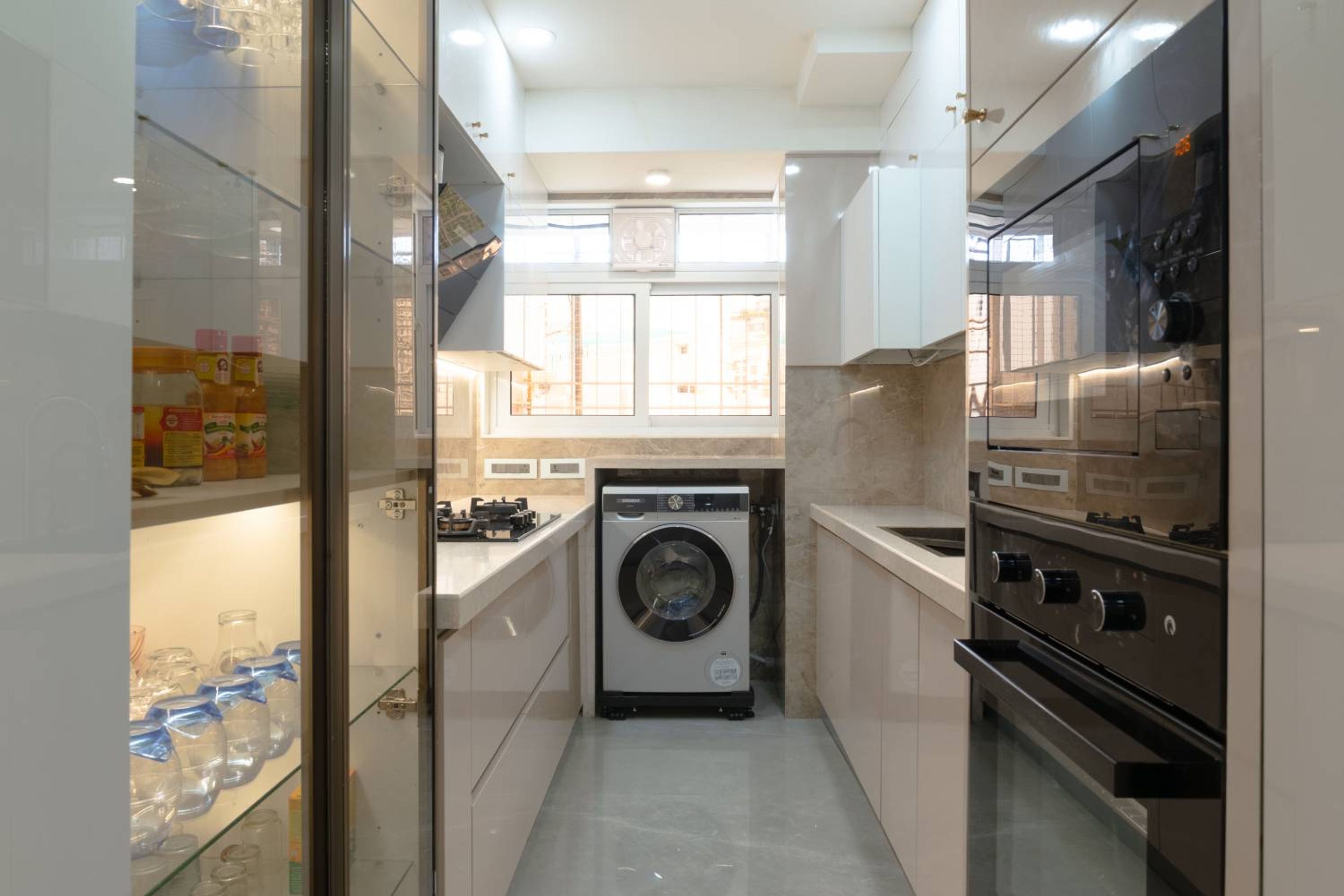 Parallel Kitchen Design with Dishwasher and Glass Shutter Crockery Unit