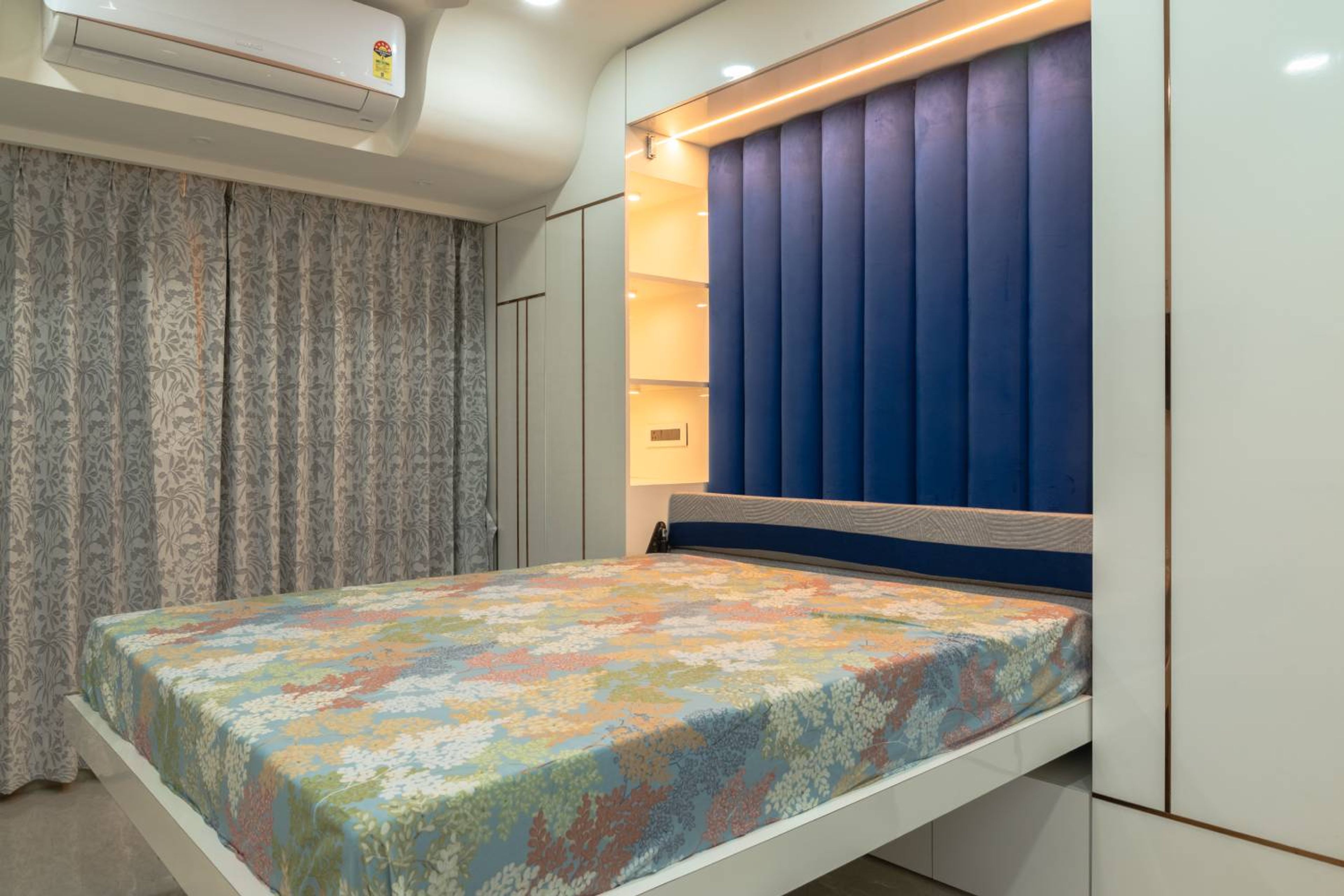 Guest Bedroom Design with Blue Tufted Headboard Wall