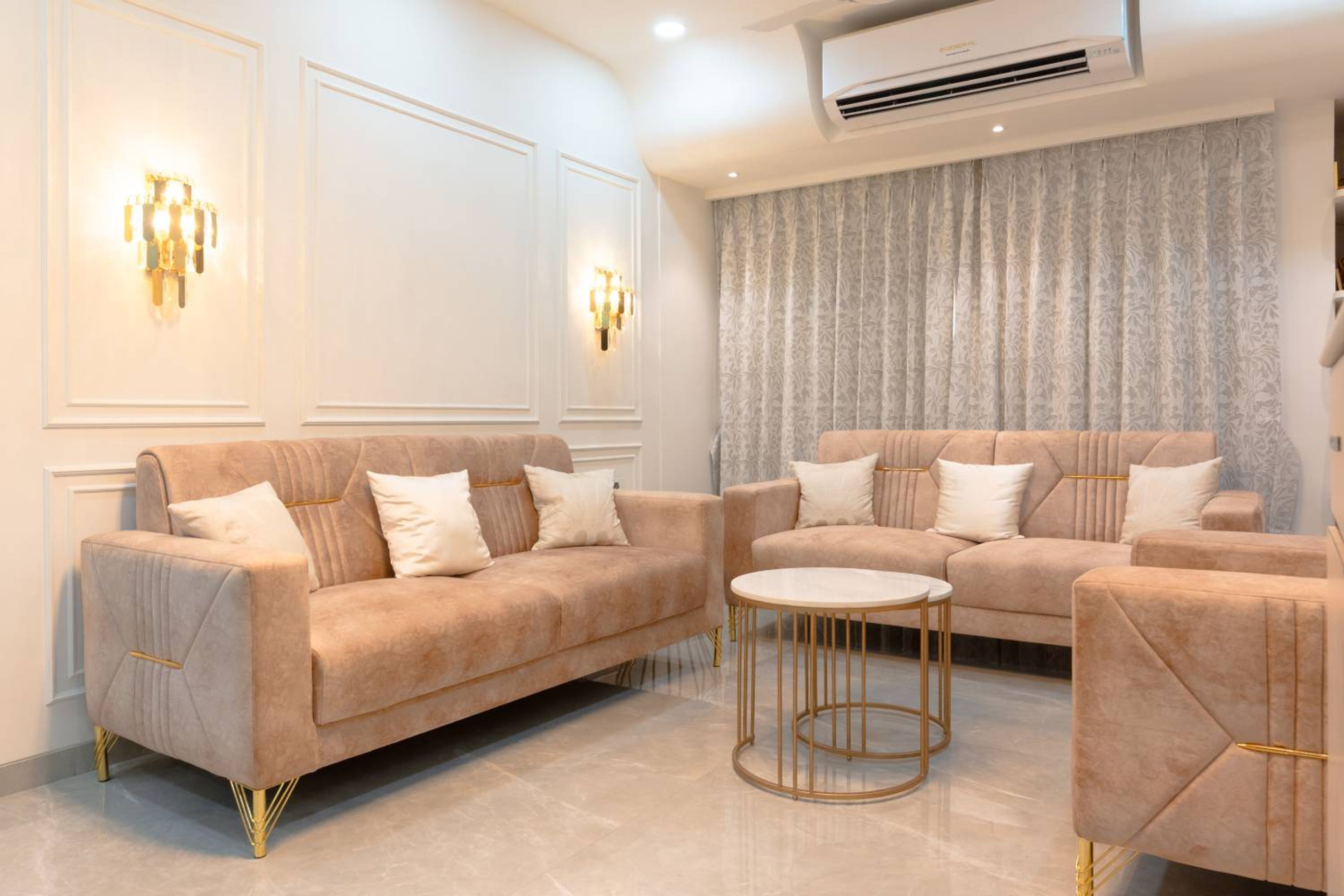Living Room Design with 3 Peach Coloured Sofas and White Panelled Wall