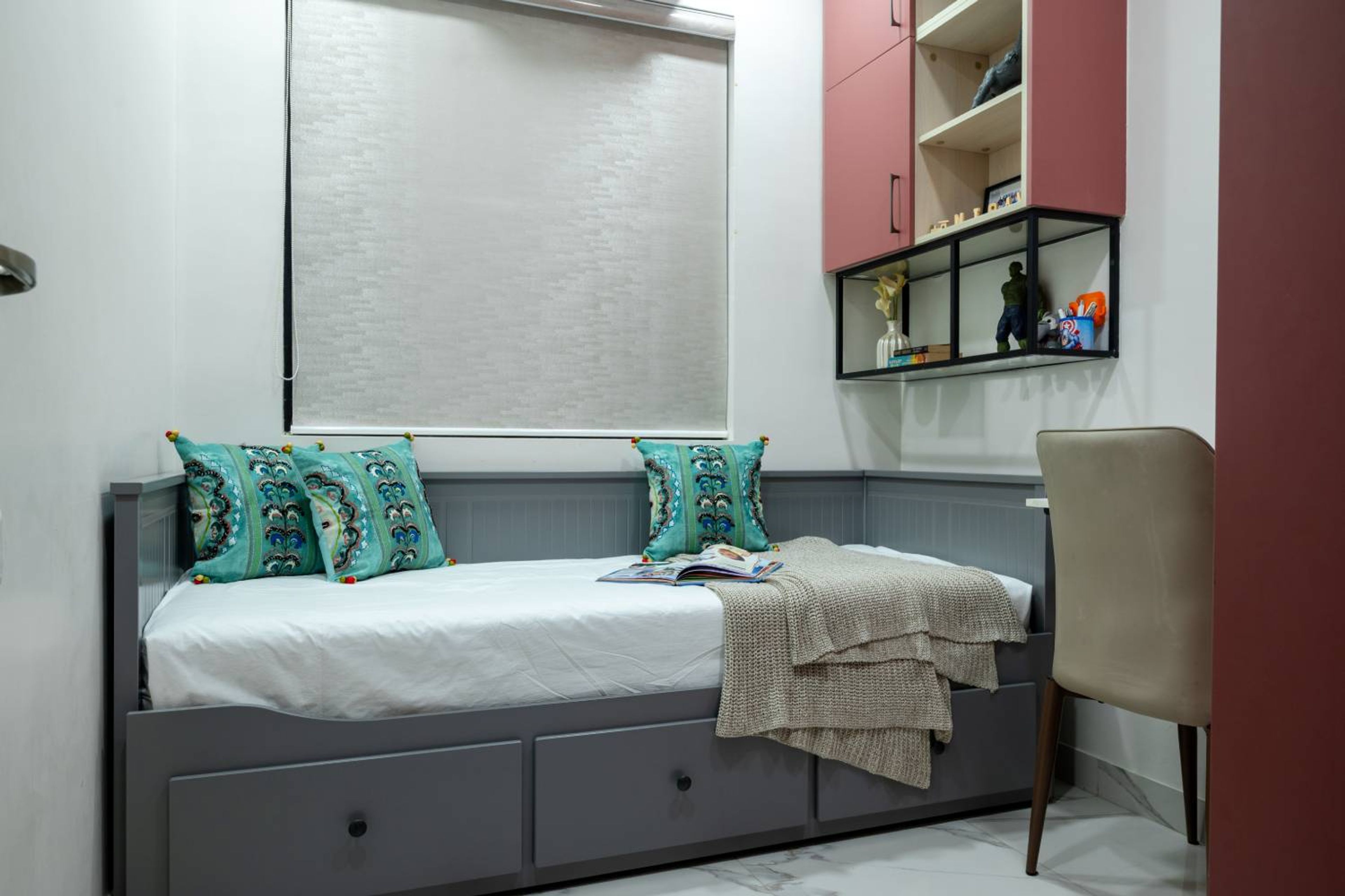 Kids Bedroom Design with Grey Storage Sofa-Cum-Bed and Pink wall Shelves