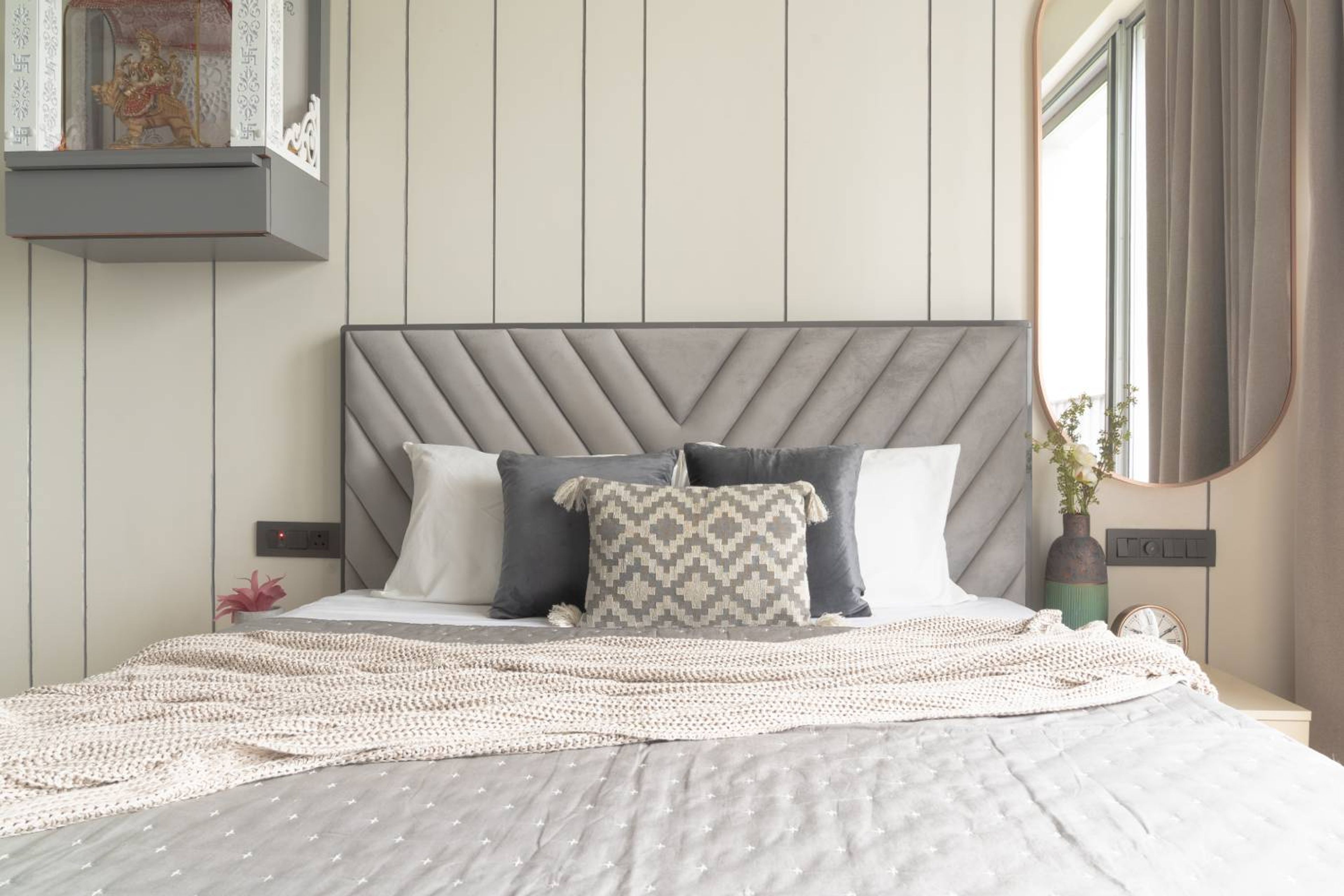 Bedroom design with grey cushioned headboard bed
