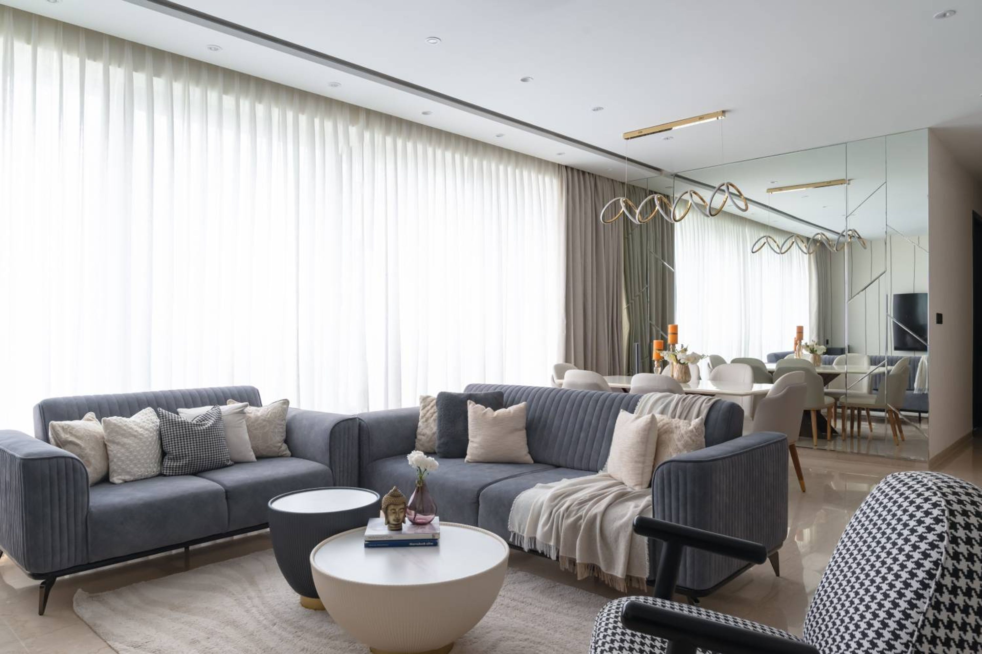 Living Room Design with Blue Cushioned Seats and Round Table