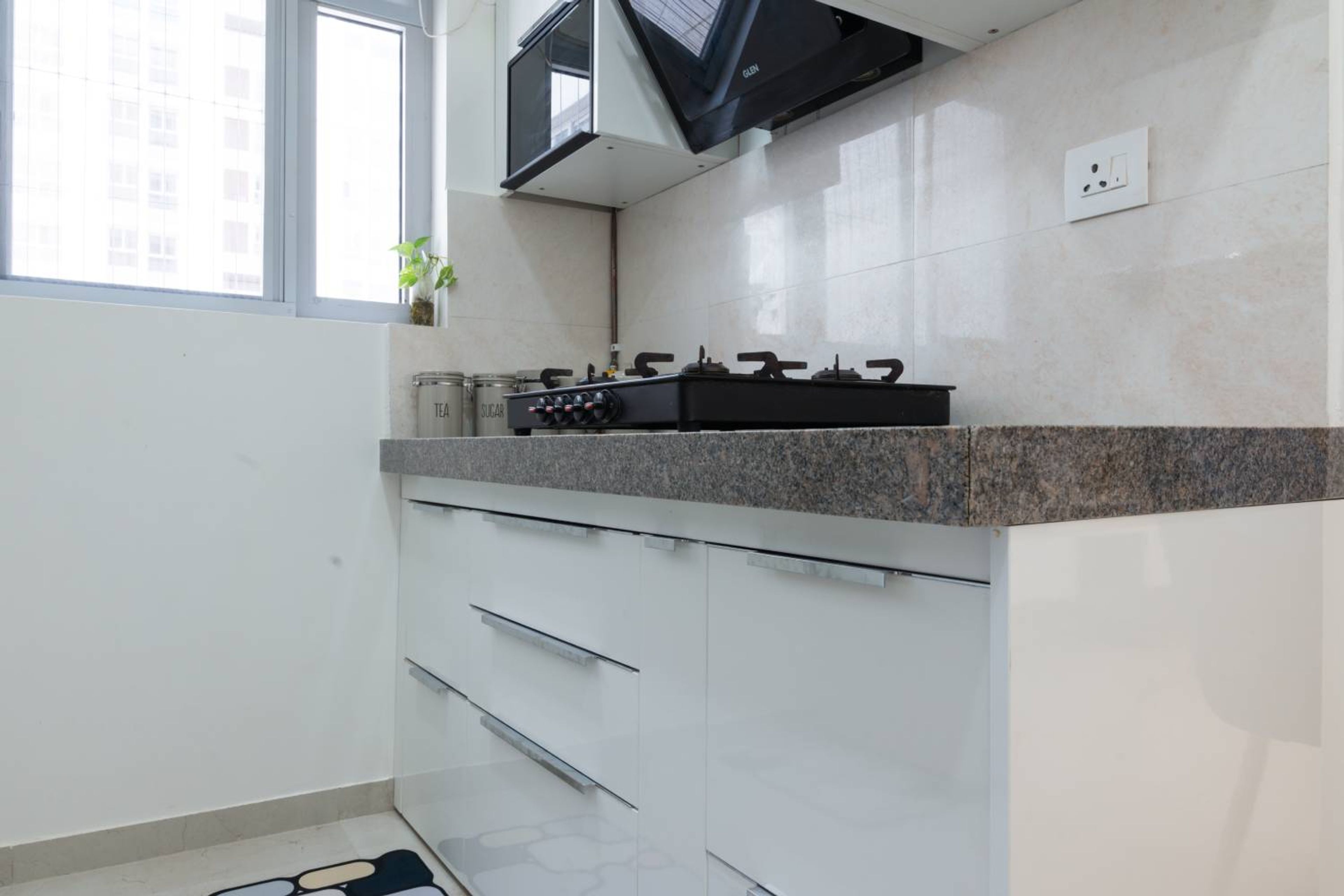 Parallel Kitchen Design with White Base Units and Granite Countertop
