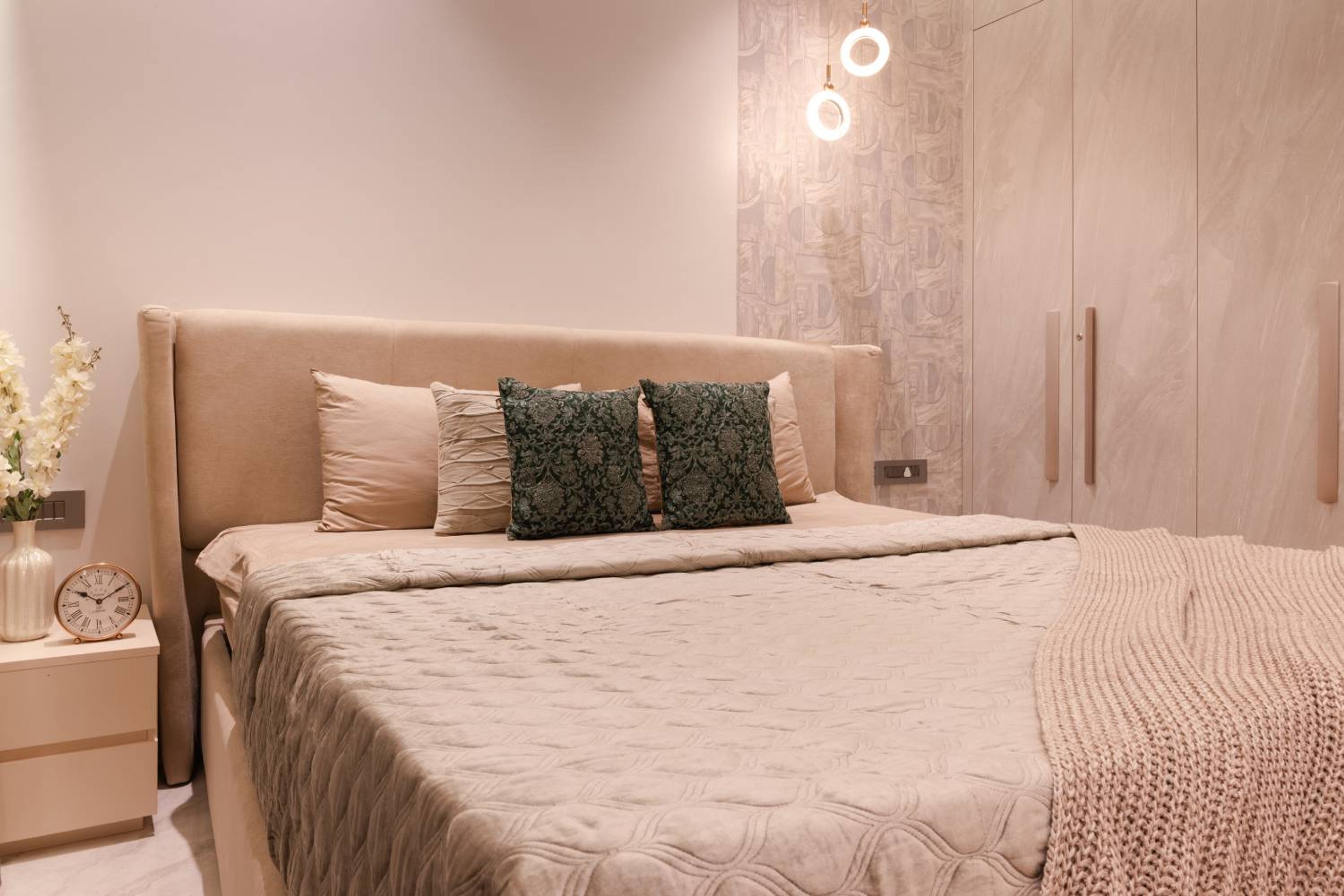 Master Bedroom Design with Pink Walls and Cushioned Headboard Bed