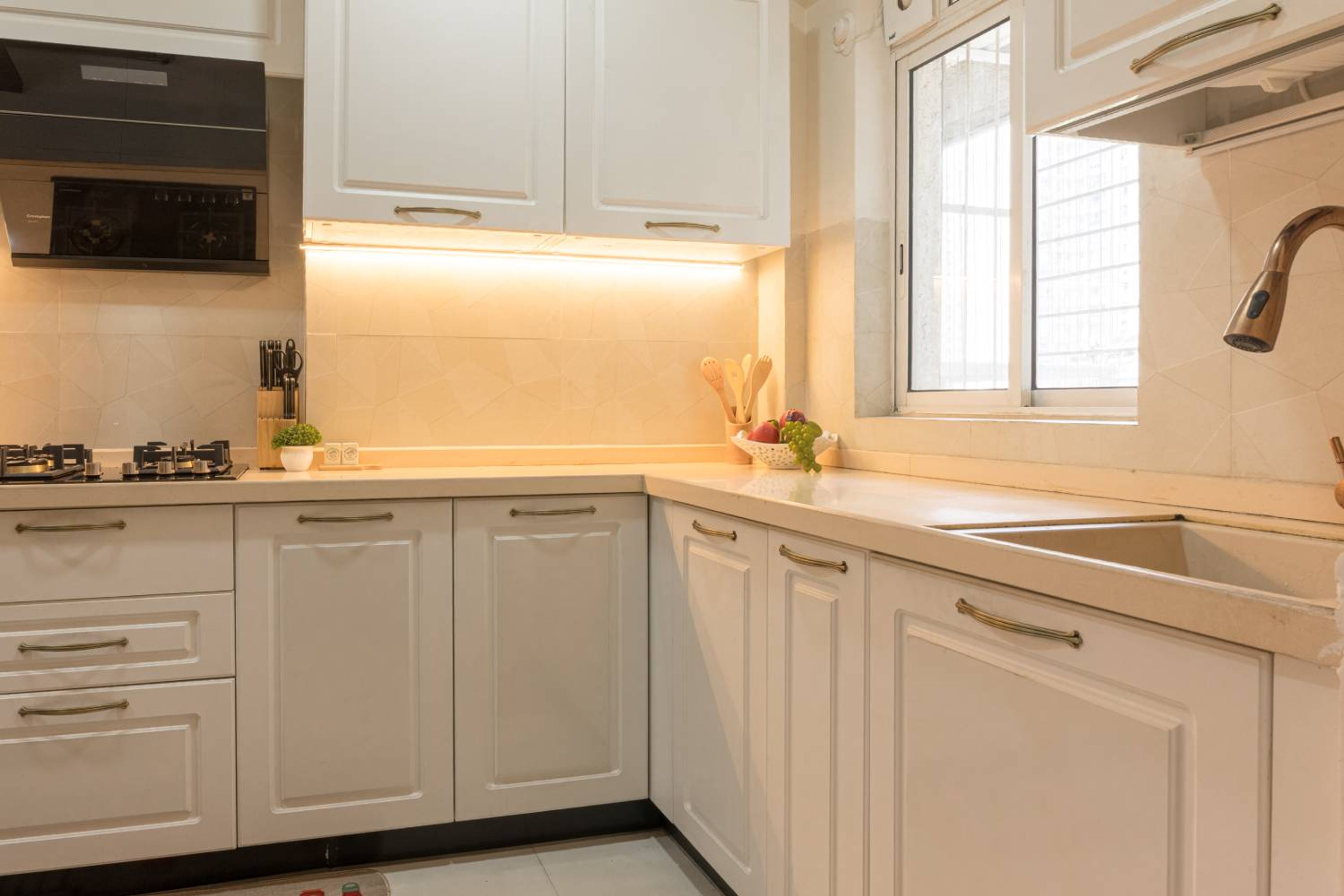 L-Shaped Kitchen Design with Under Cabinet Lighting and Quartz Countertop