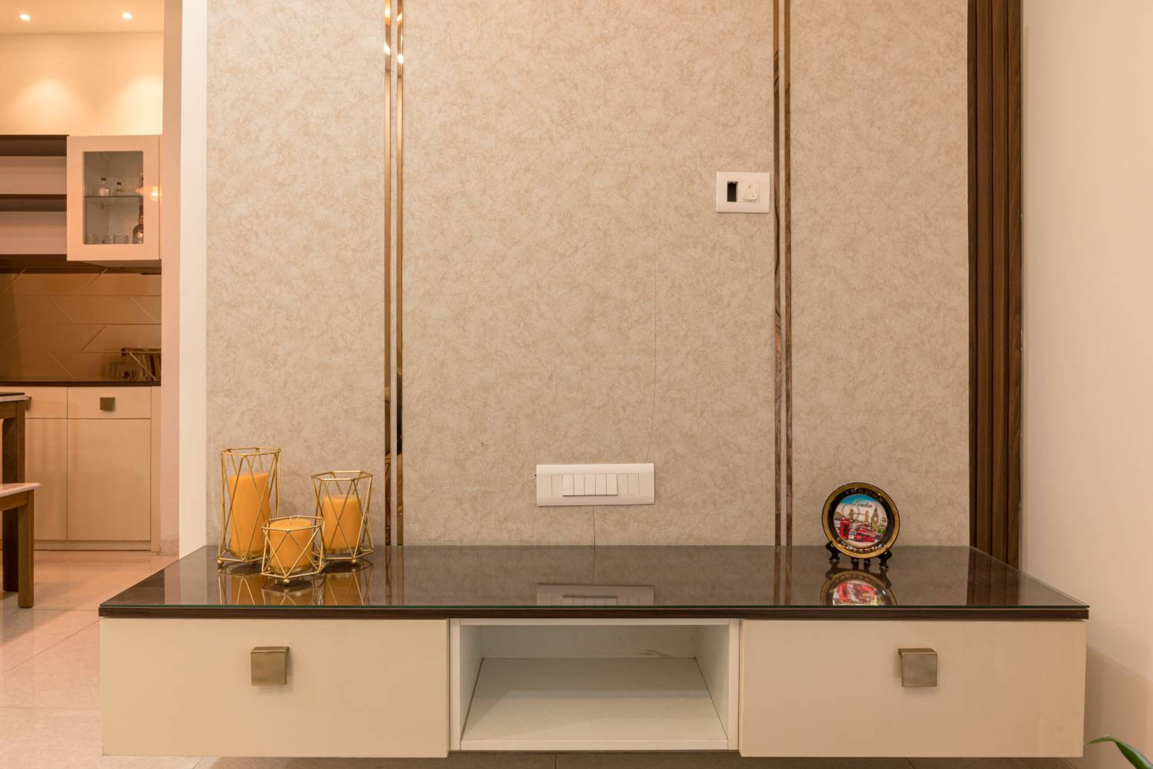 TV Unit Design with Marble Patterned Backsplash with Gold Inlays and Wall Mounted Drawers