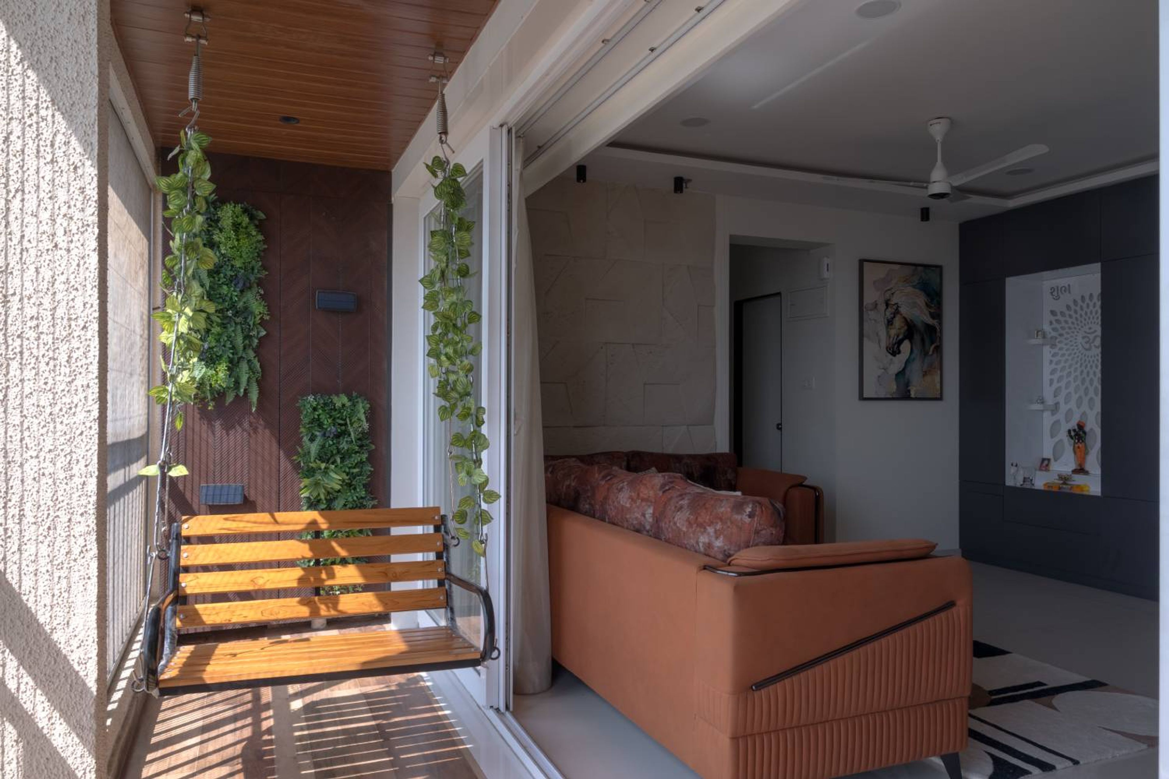 Living room design with wooden swing in the balcony