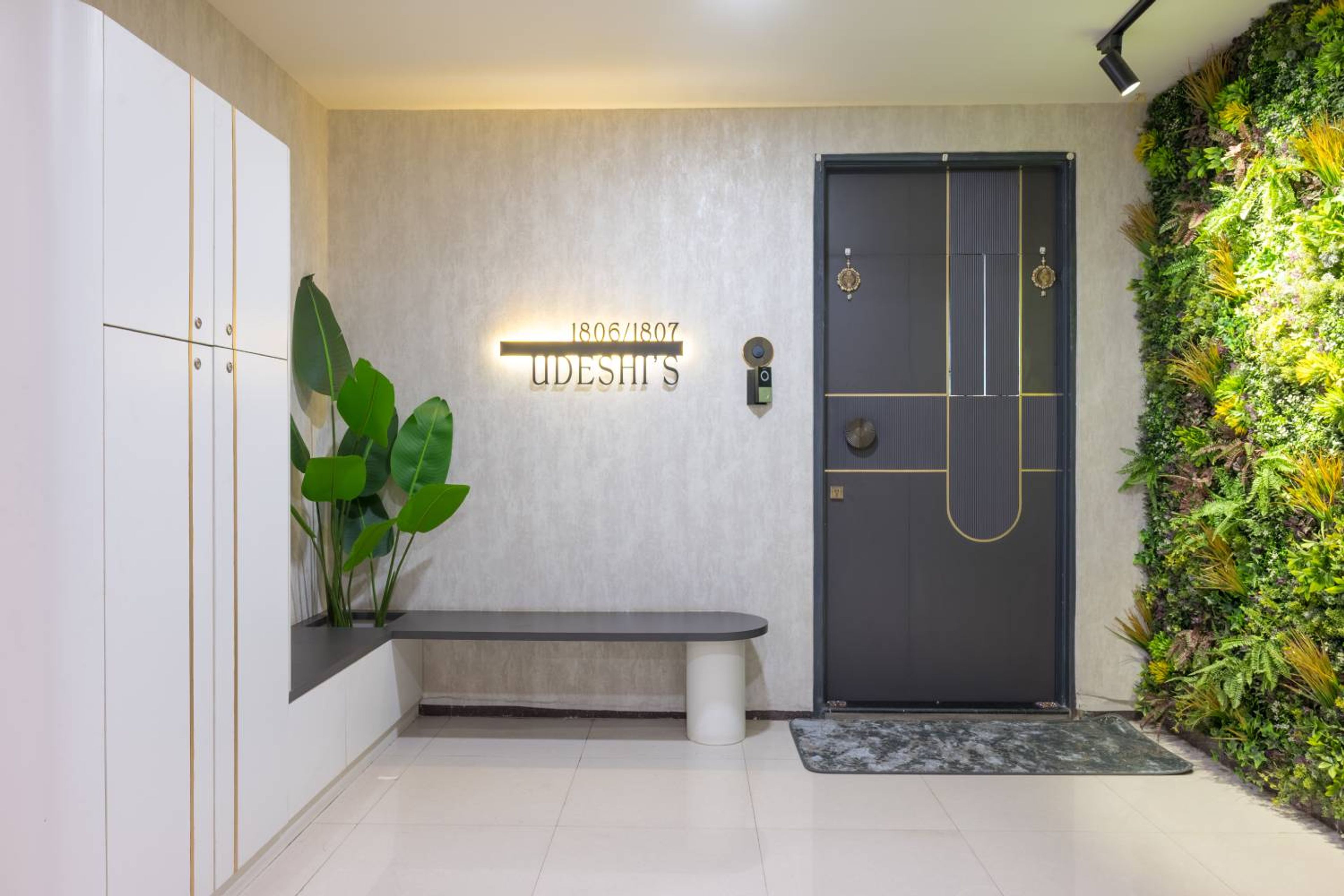 Foyer design with grey single swing door and seating space