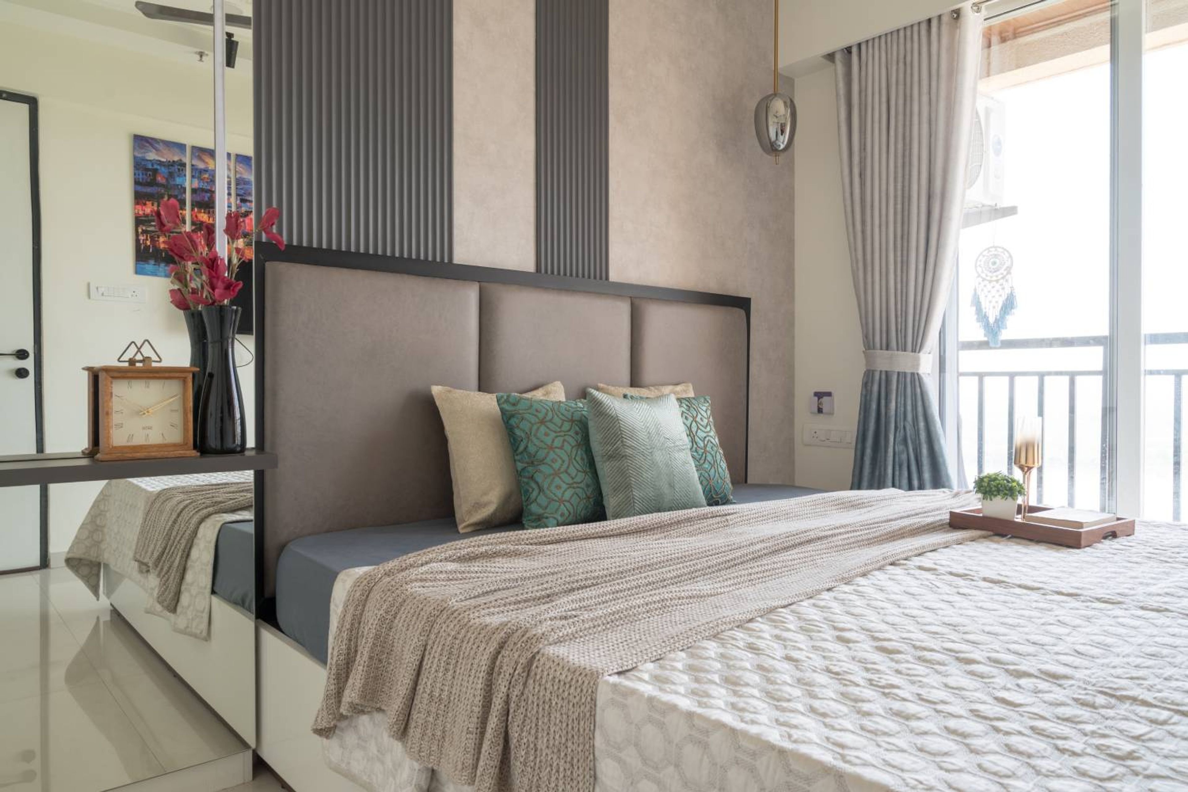 Bedroom design with grey cushioned headboard bed