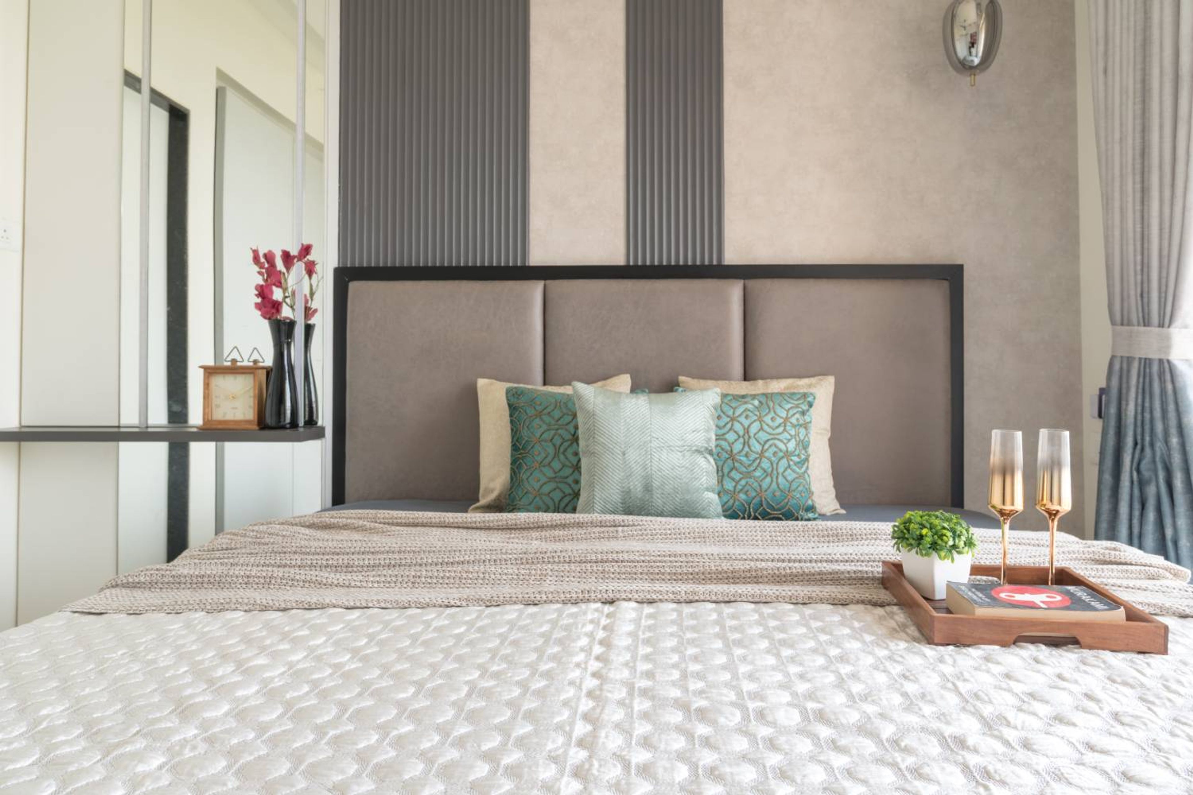 Bedroom design with grey cushioned headboard bed