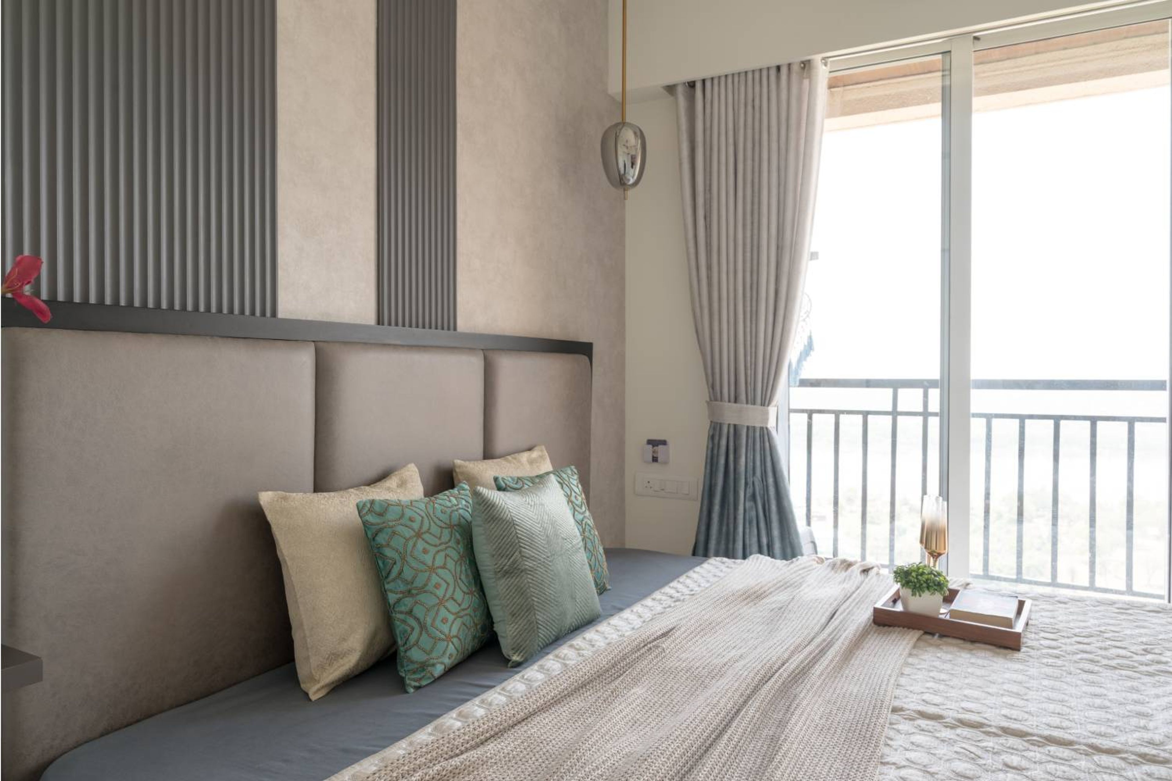 Bedroom design with grey cushioned headboard bed