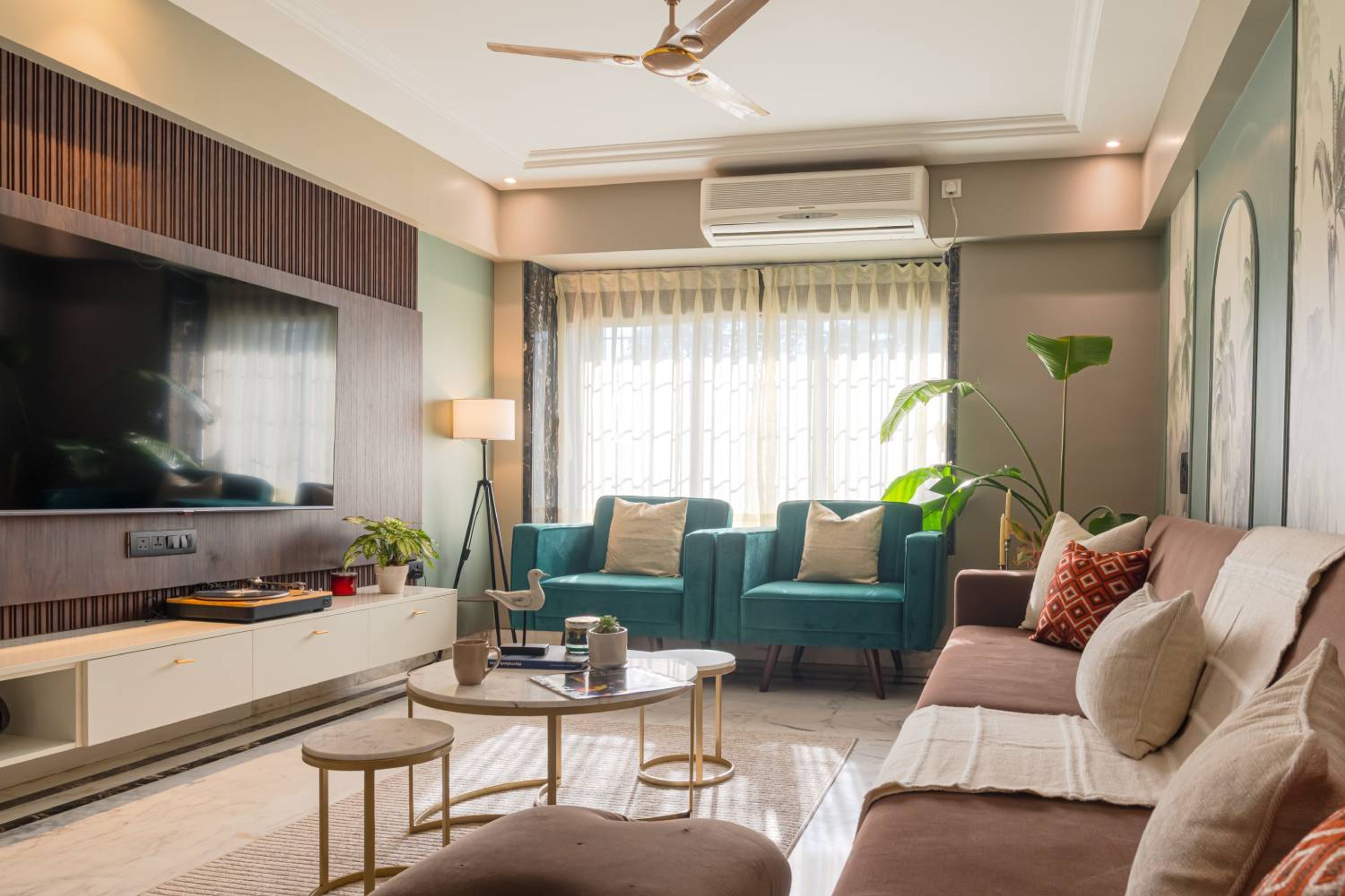 Living Room Design with Wooden TV Unit, 2 Single Seater Blue Sofas and a Light Brown Sofa