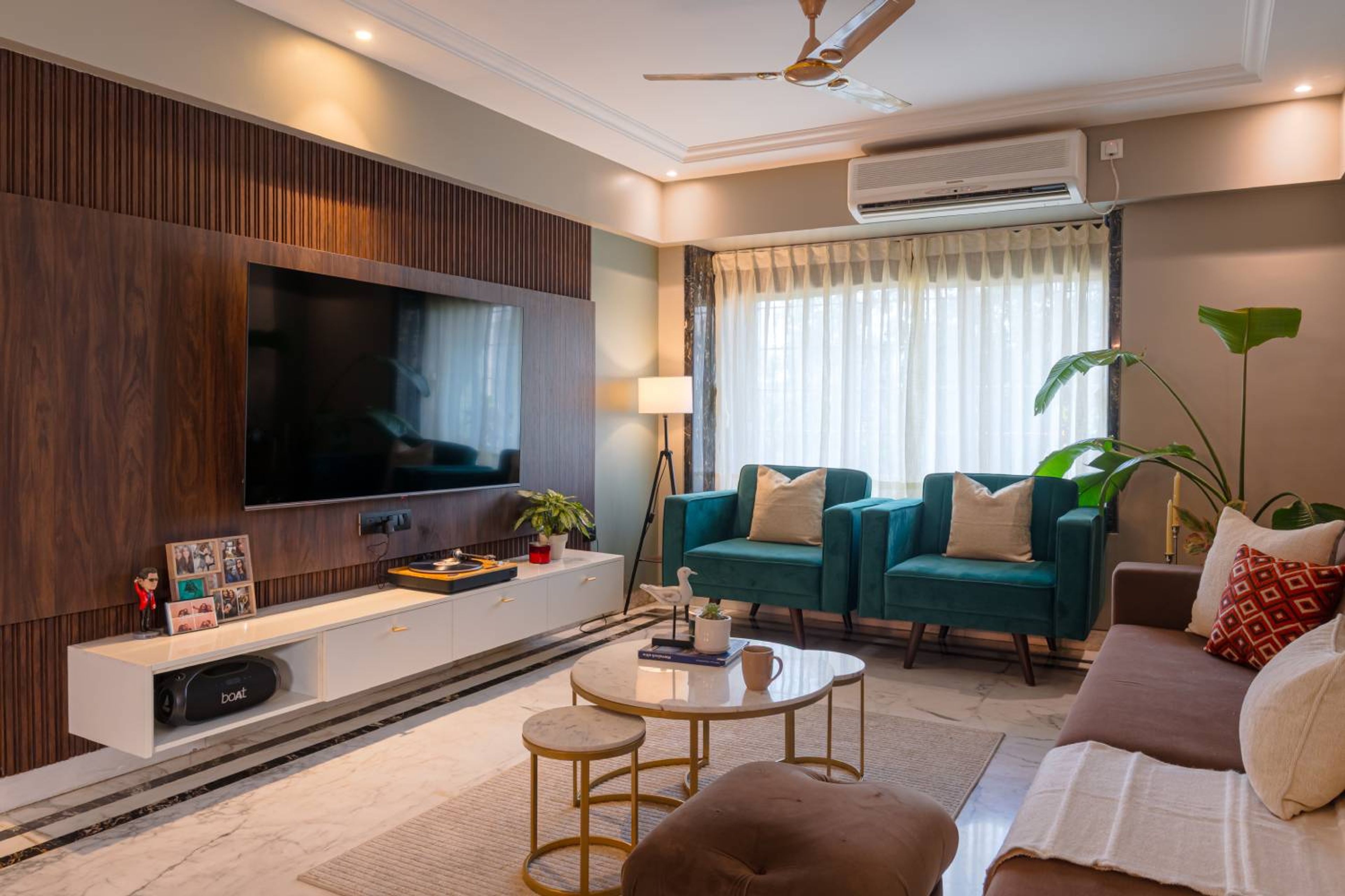 Living Room Design with Wooden TV Unit with White Wall Mounted Drawer and Blue and Light Brown Sofas