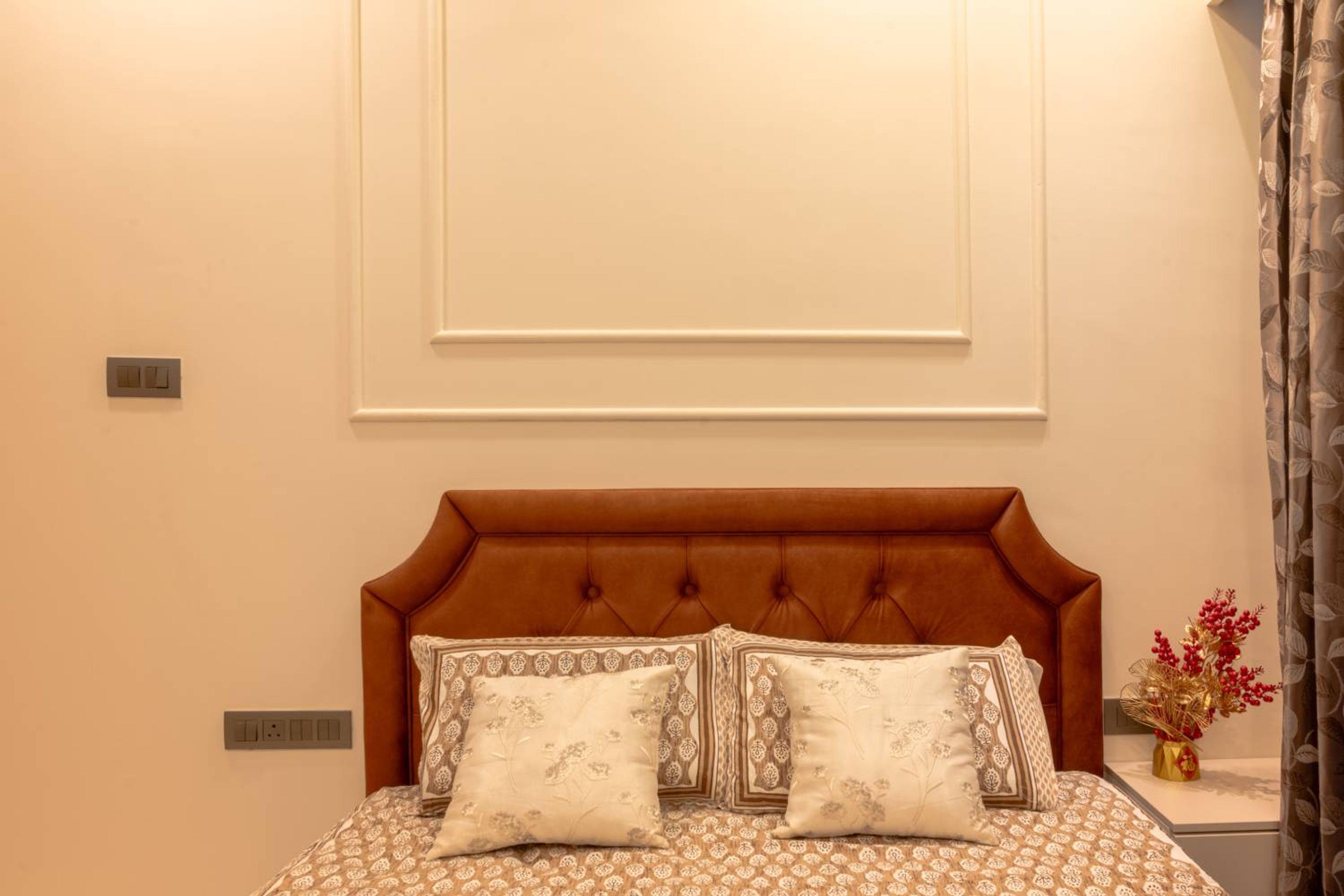 Guest Bedroom Design with Brown Tufted Headboard Bed and Off-White Panelled Wall