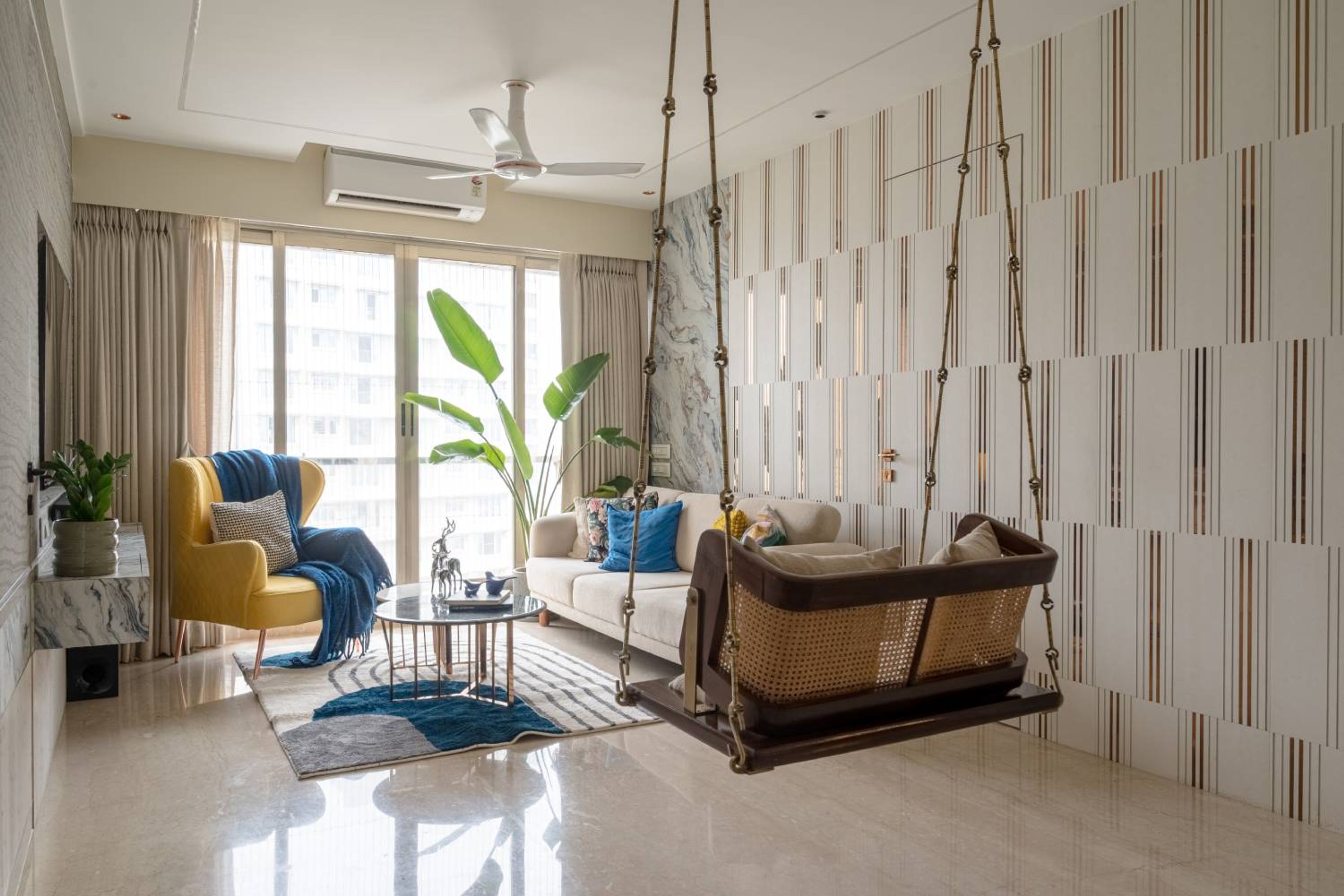 Living room design with off white sofa, yellow accent chair and swing