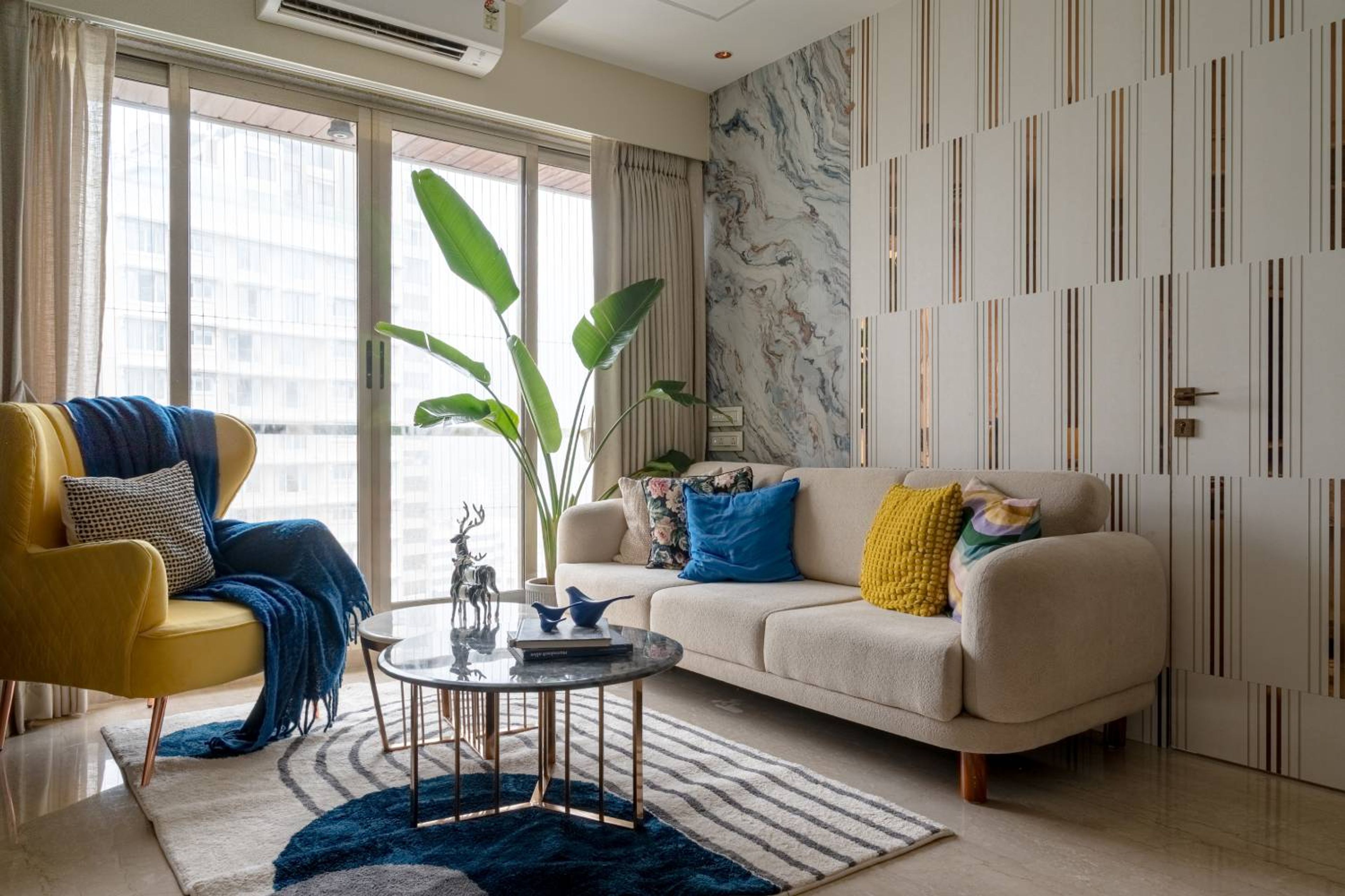 Living room design with off white sofa and yellow accent chair