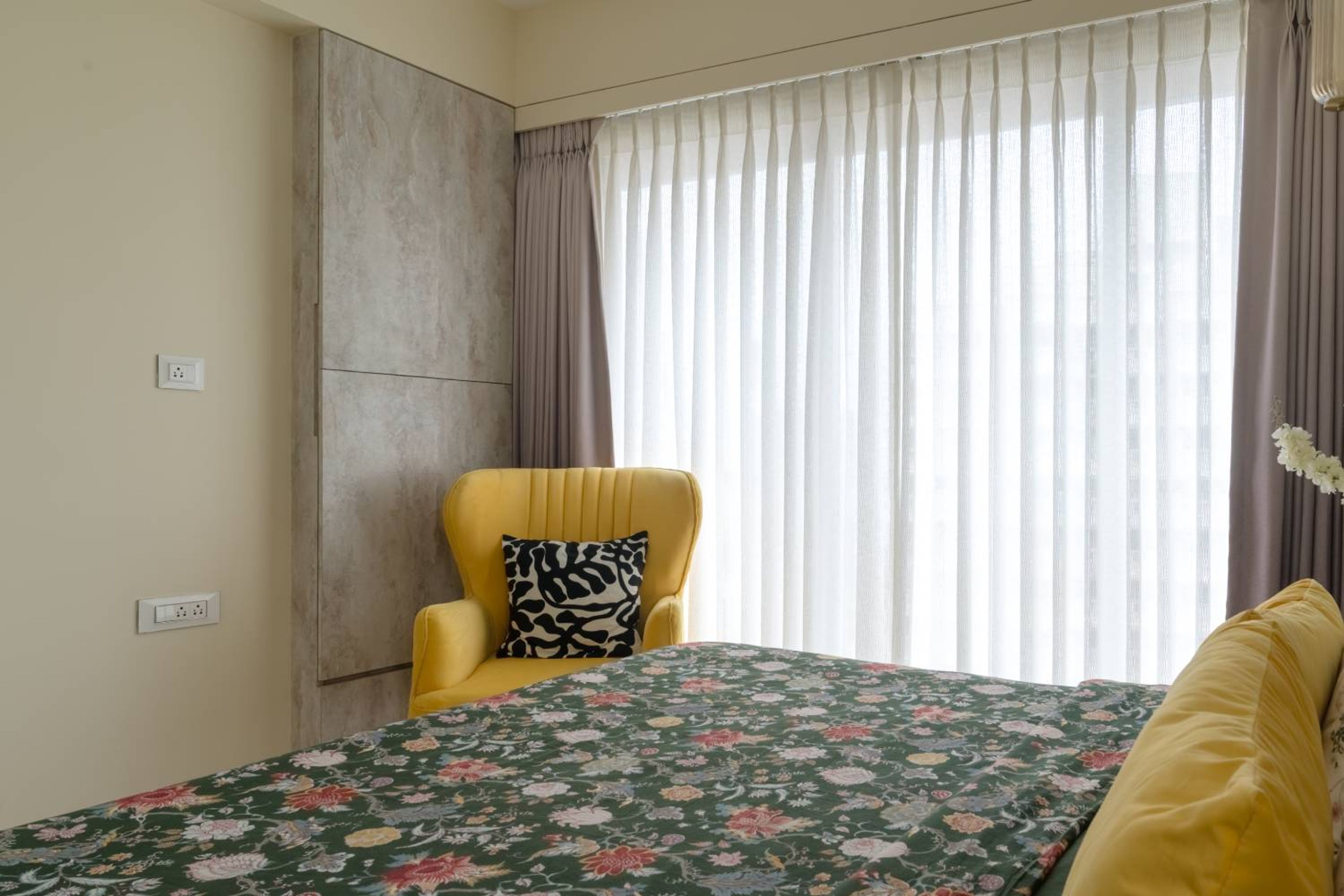 Bedroom design with yellow accent chair