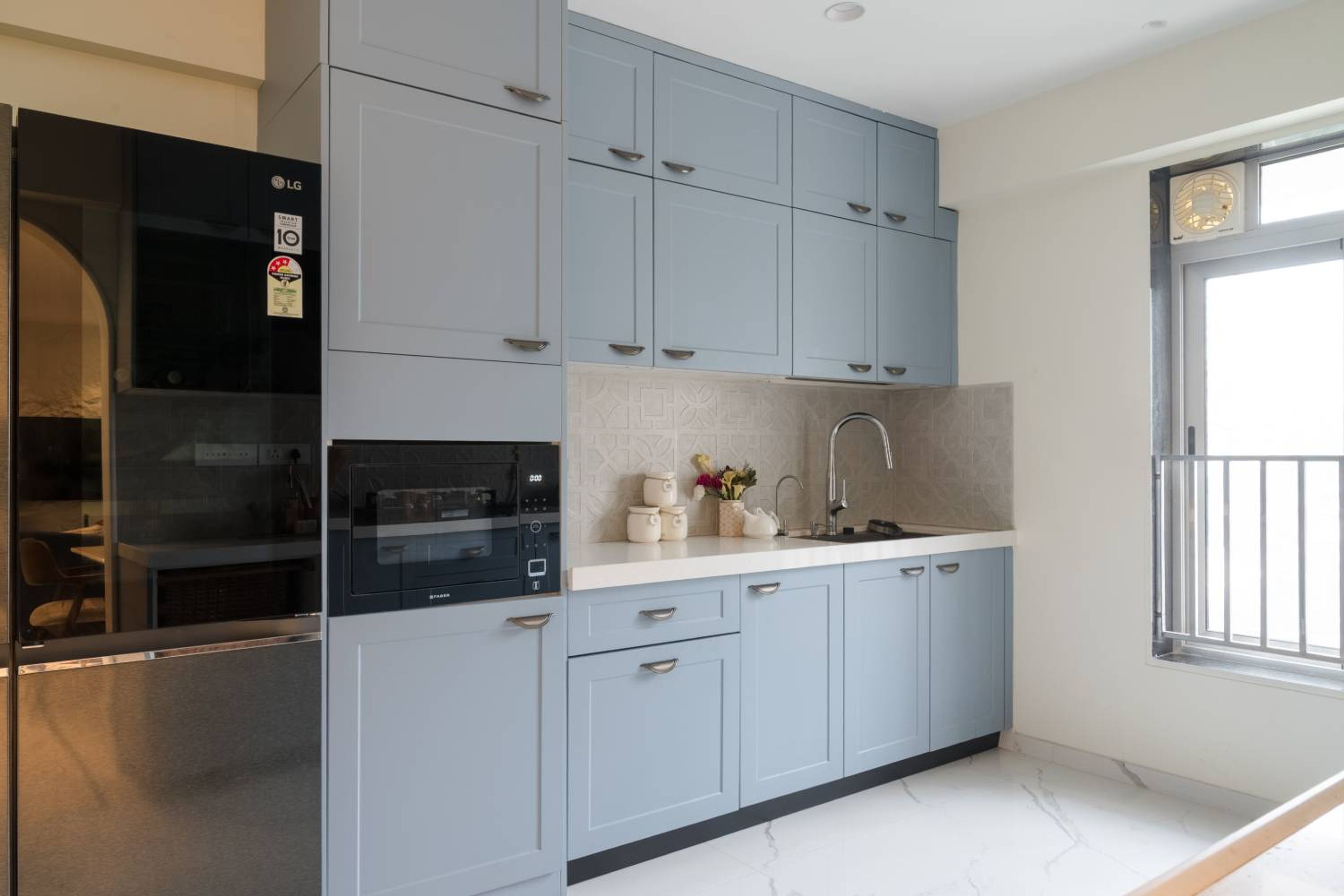 Modern Blue Parallel Kitchen Design With Shaker Cabinets And Patterned Backsplash