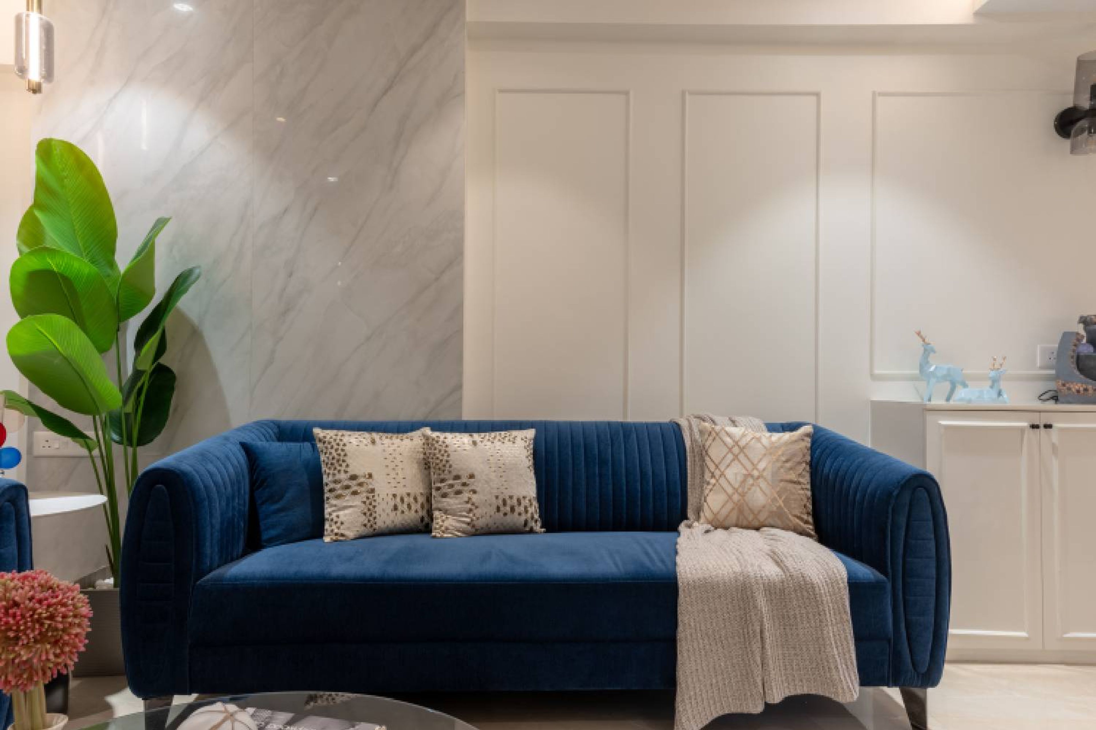 Blue Living Room Design With Floating TV and Marble Accents