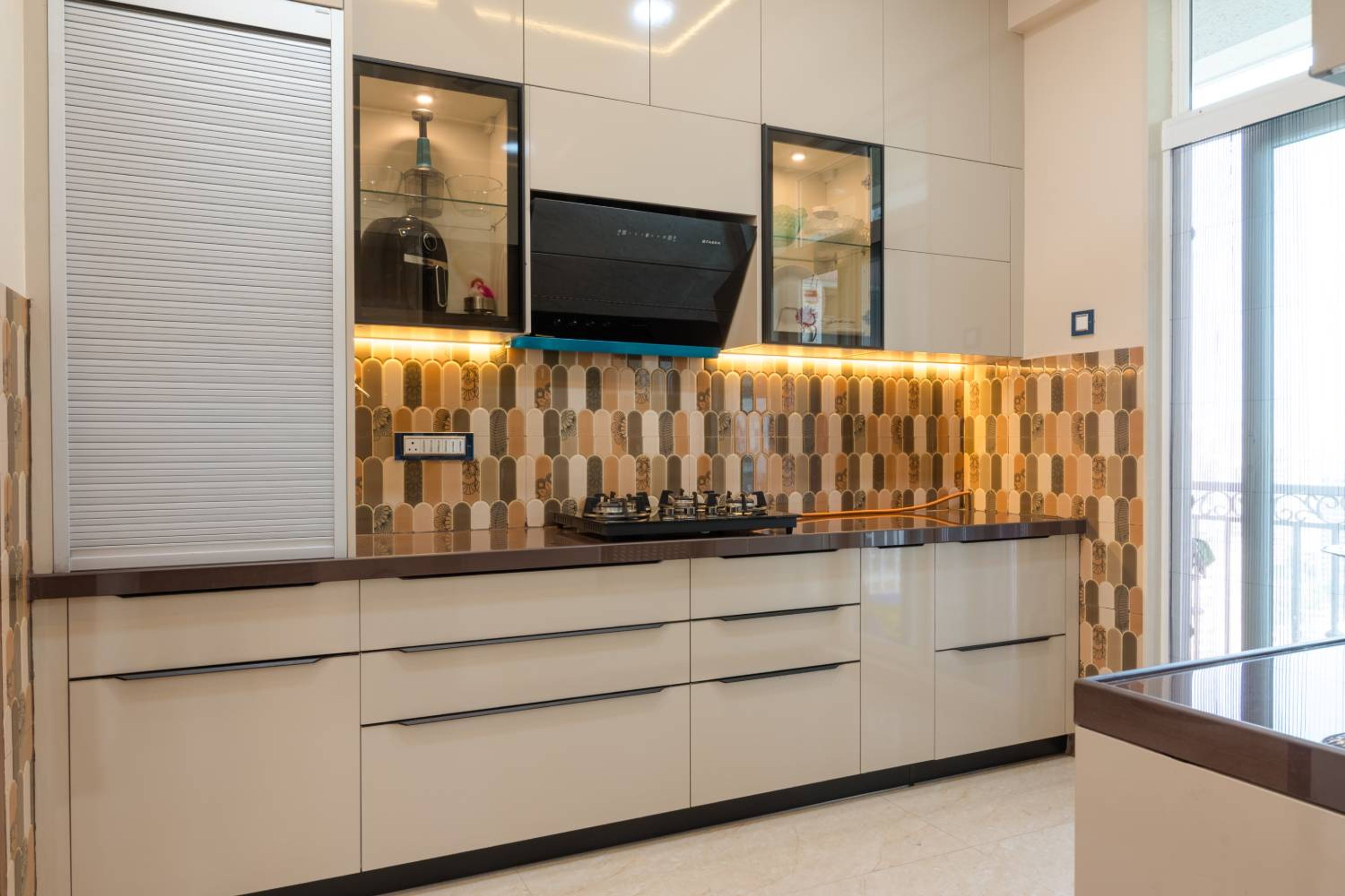 Parallel kitchen design with beige units and moroccan tiles backsplash