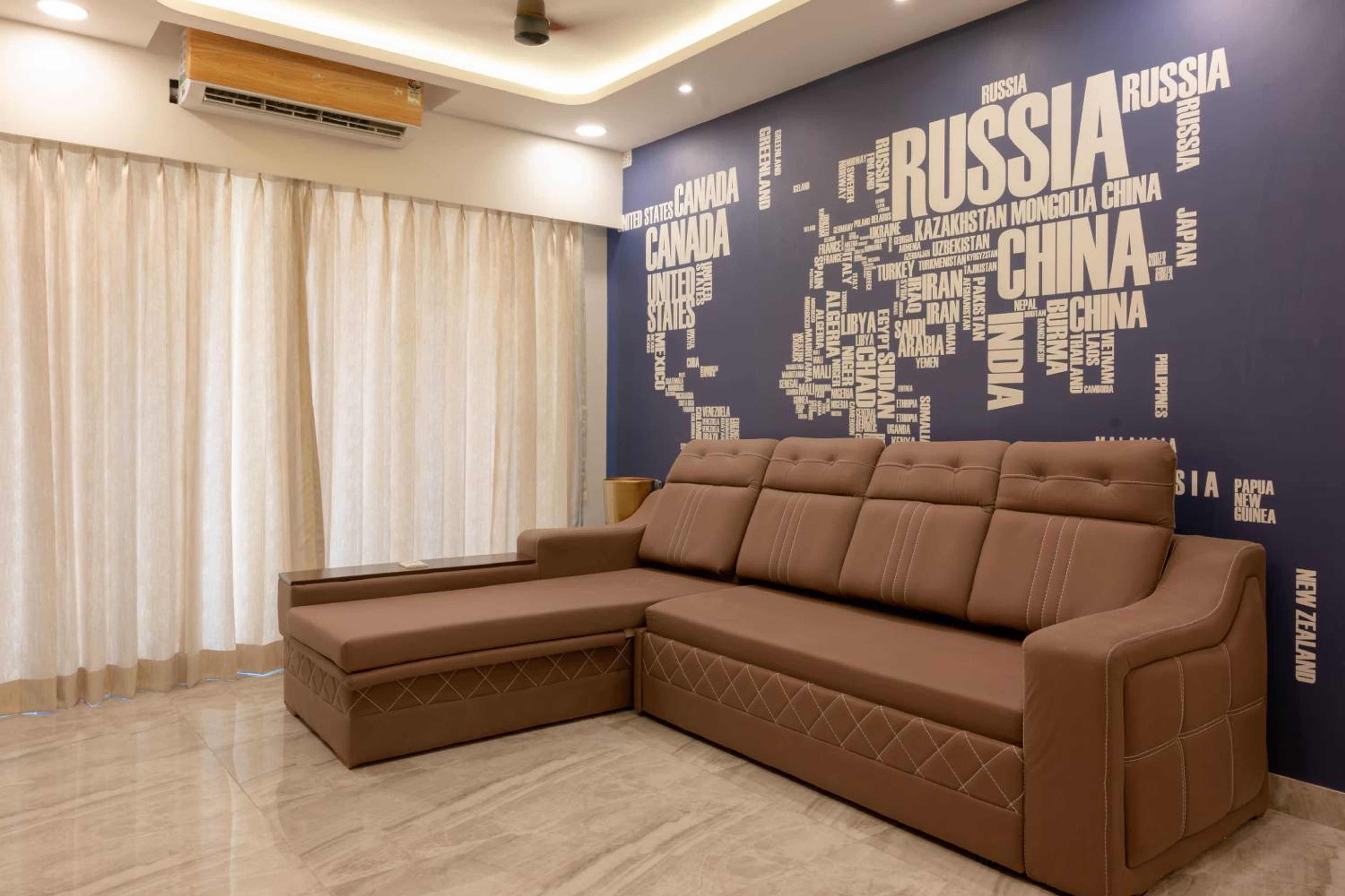 Living Room Design with Brown L-Shaped Sofa and World Map Wallpaper
