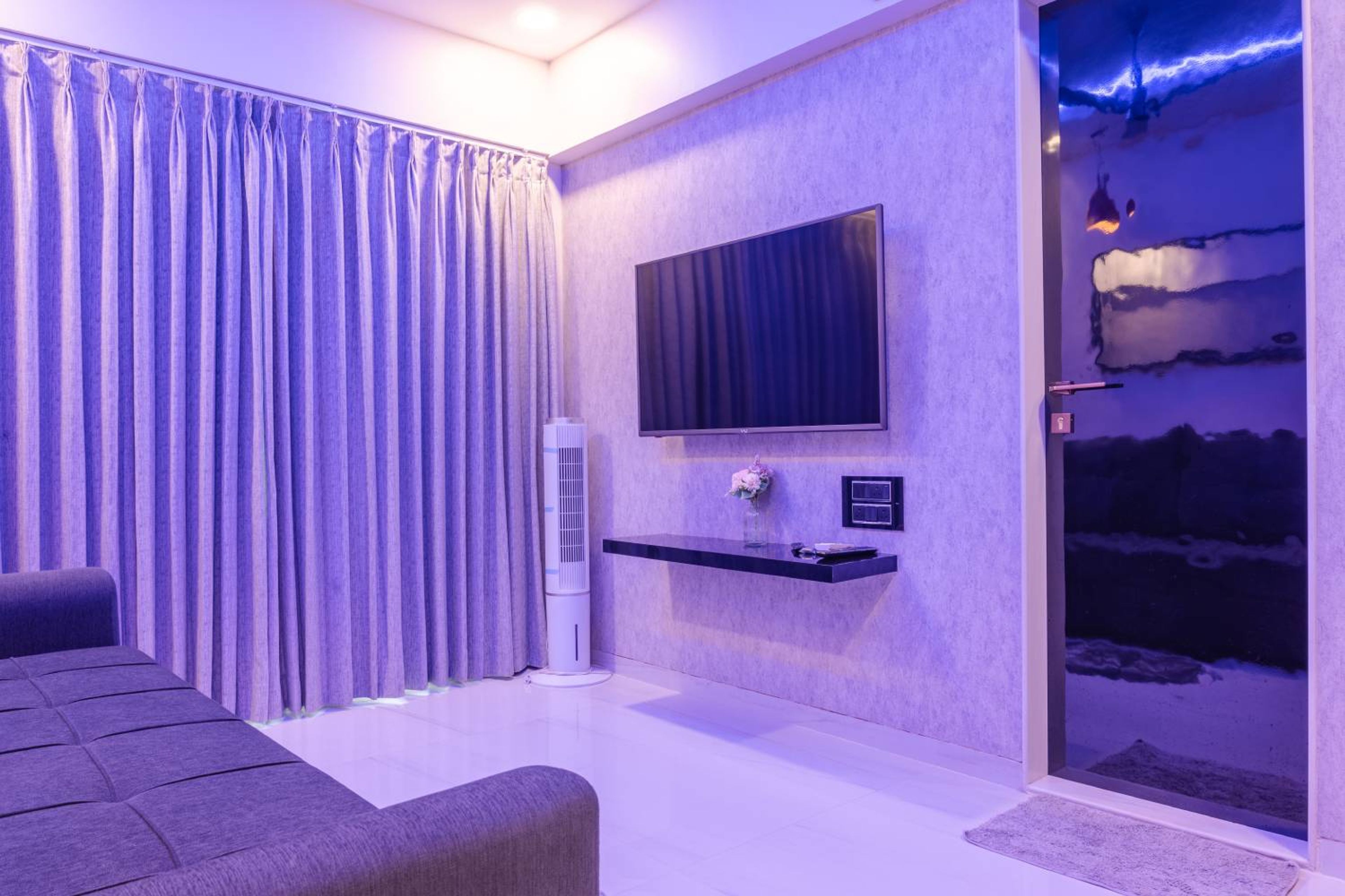 Purple Walls and Sleek Sofa Space Saving Design