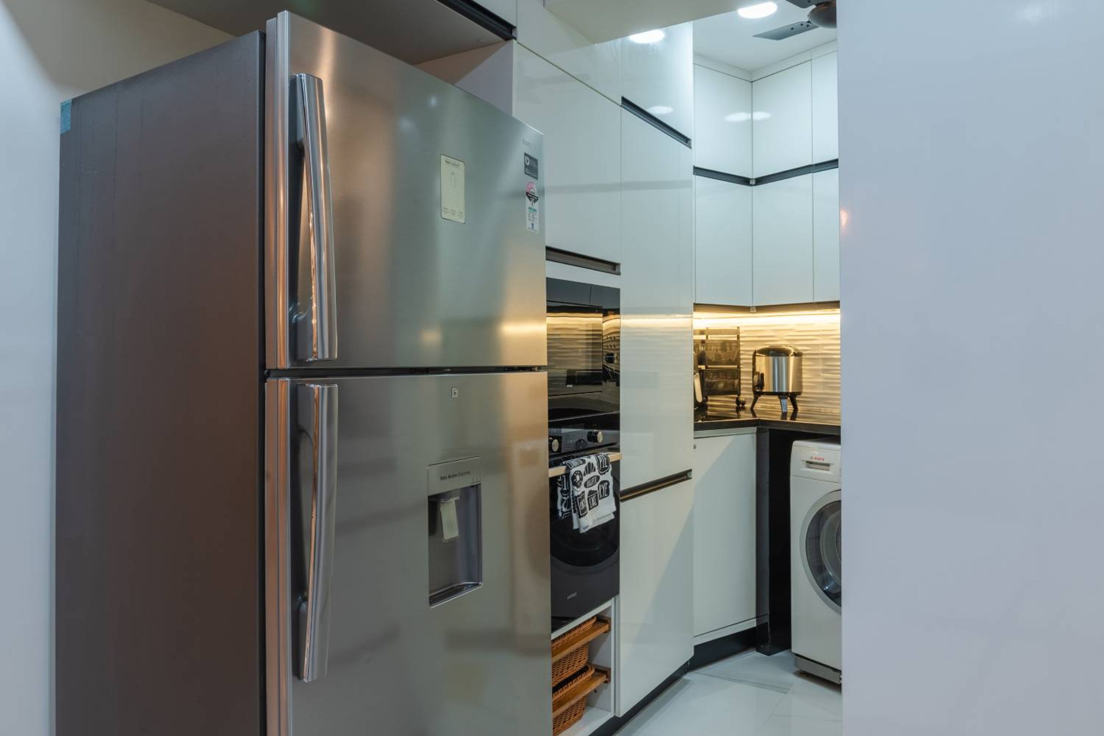 L-Shaped Kitchen Design with Fridge, Oven and Wicker Baskets