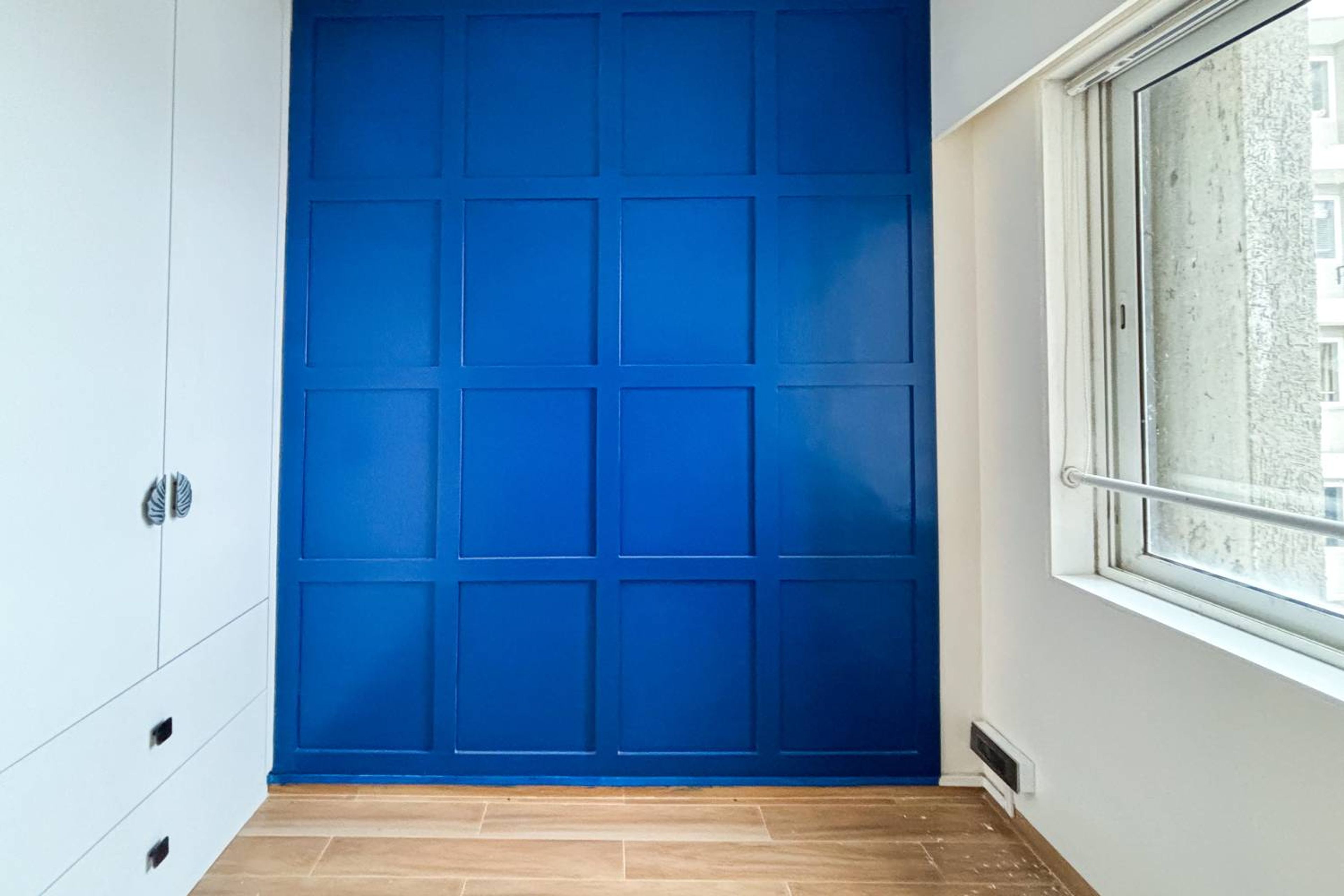 Bright blue wall design with square panels